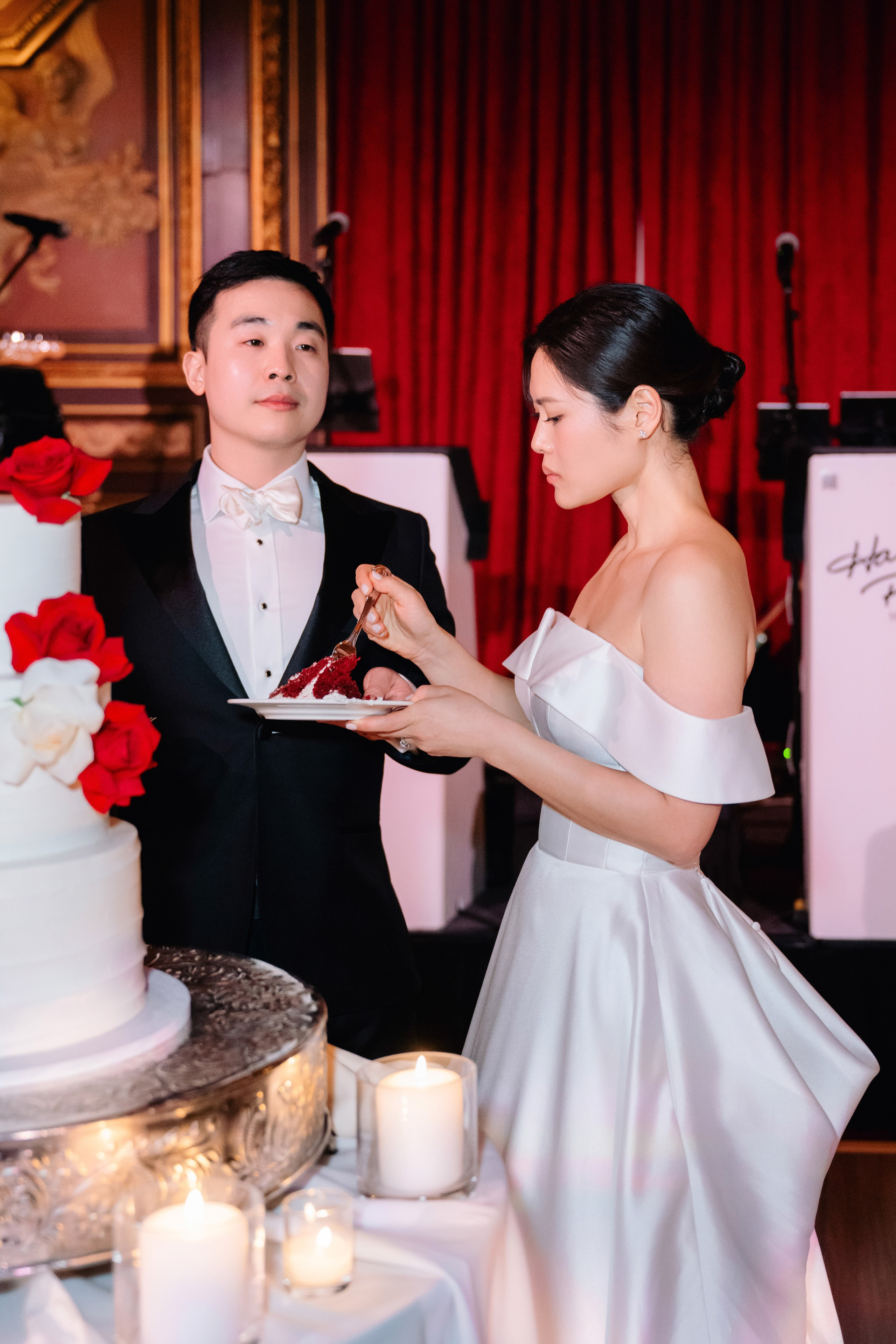 a man and woman cutting a cake together