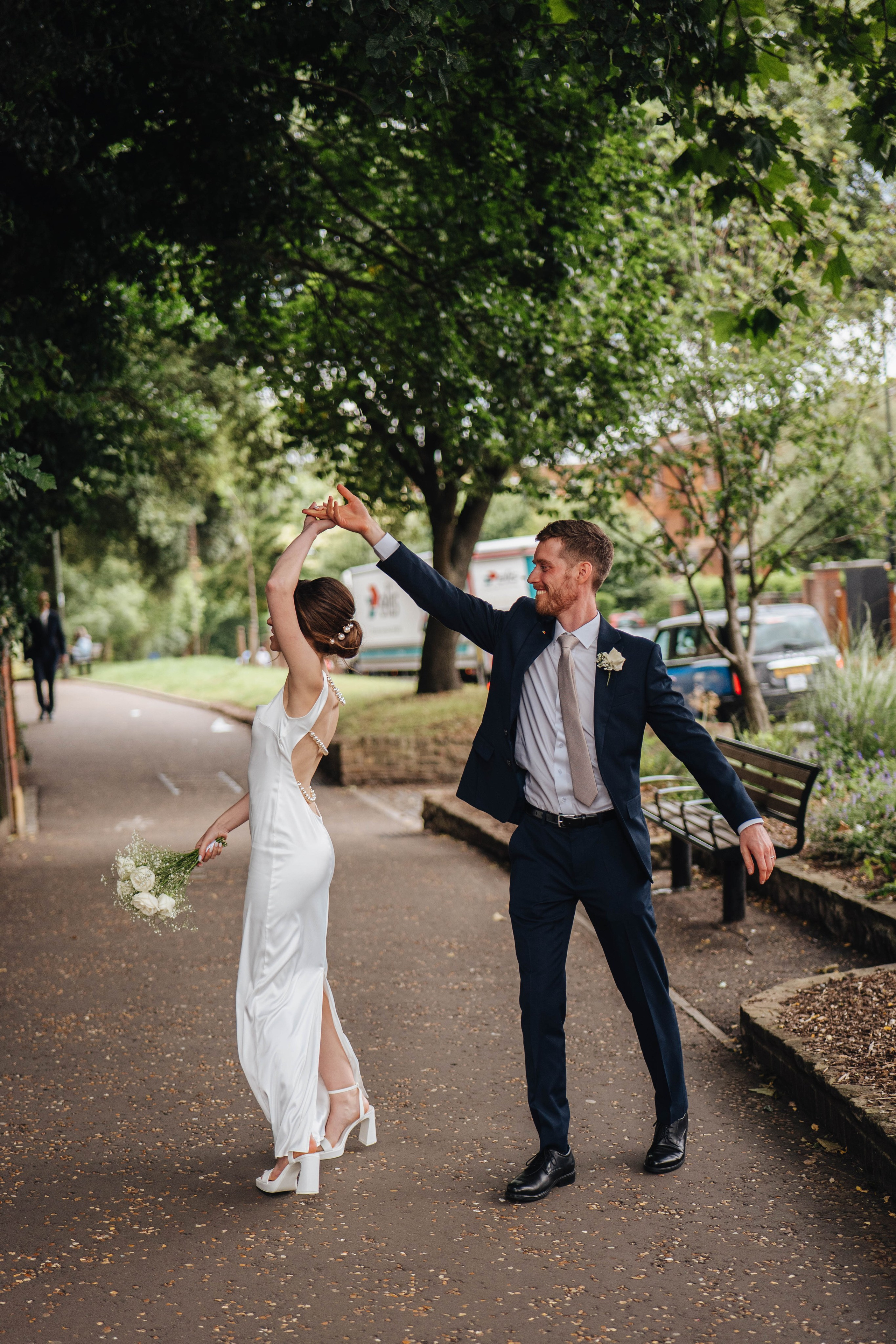 bride and groom dancing on the street in London