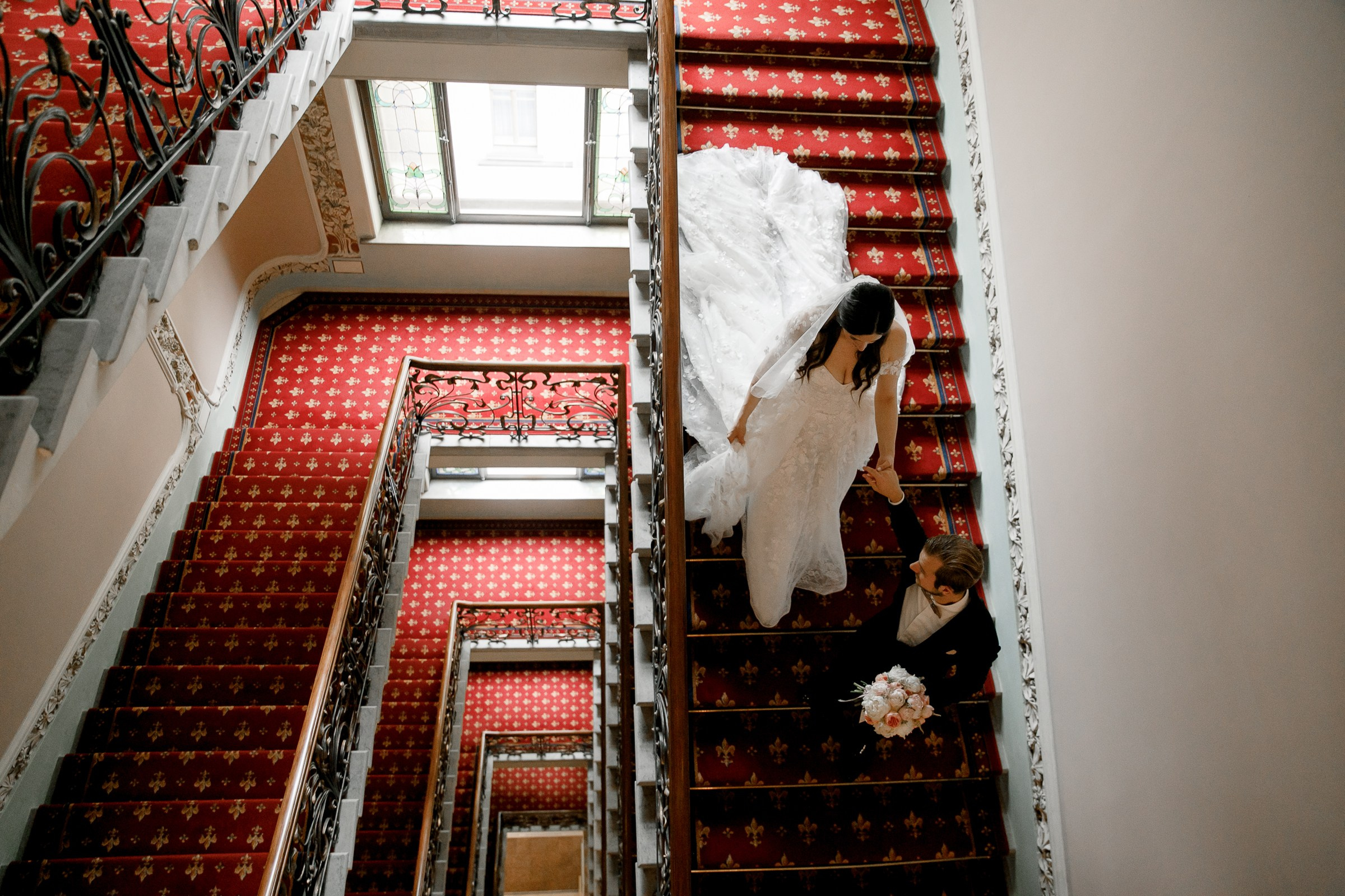 Bride and groom walk on staircase , by Bude, Cornwall reportage photographer.