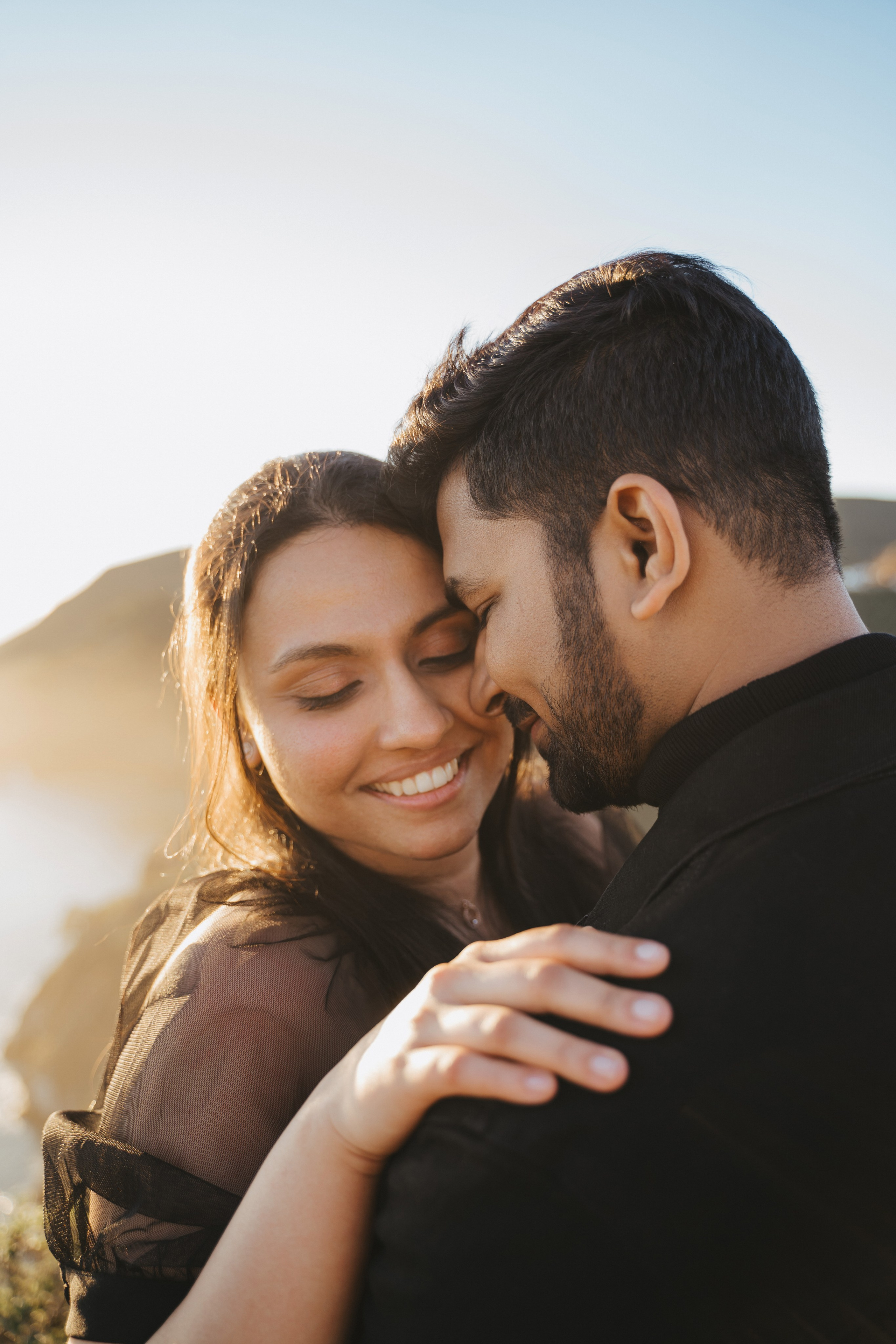 Proposal.  Overlooking the golden San Franisco Bridge sunset with a couple. Photographer Video. 
