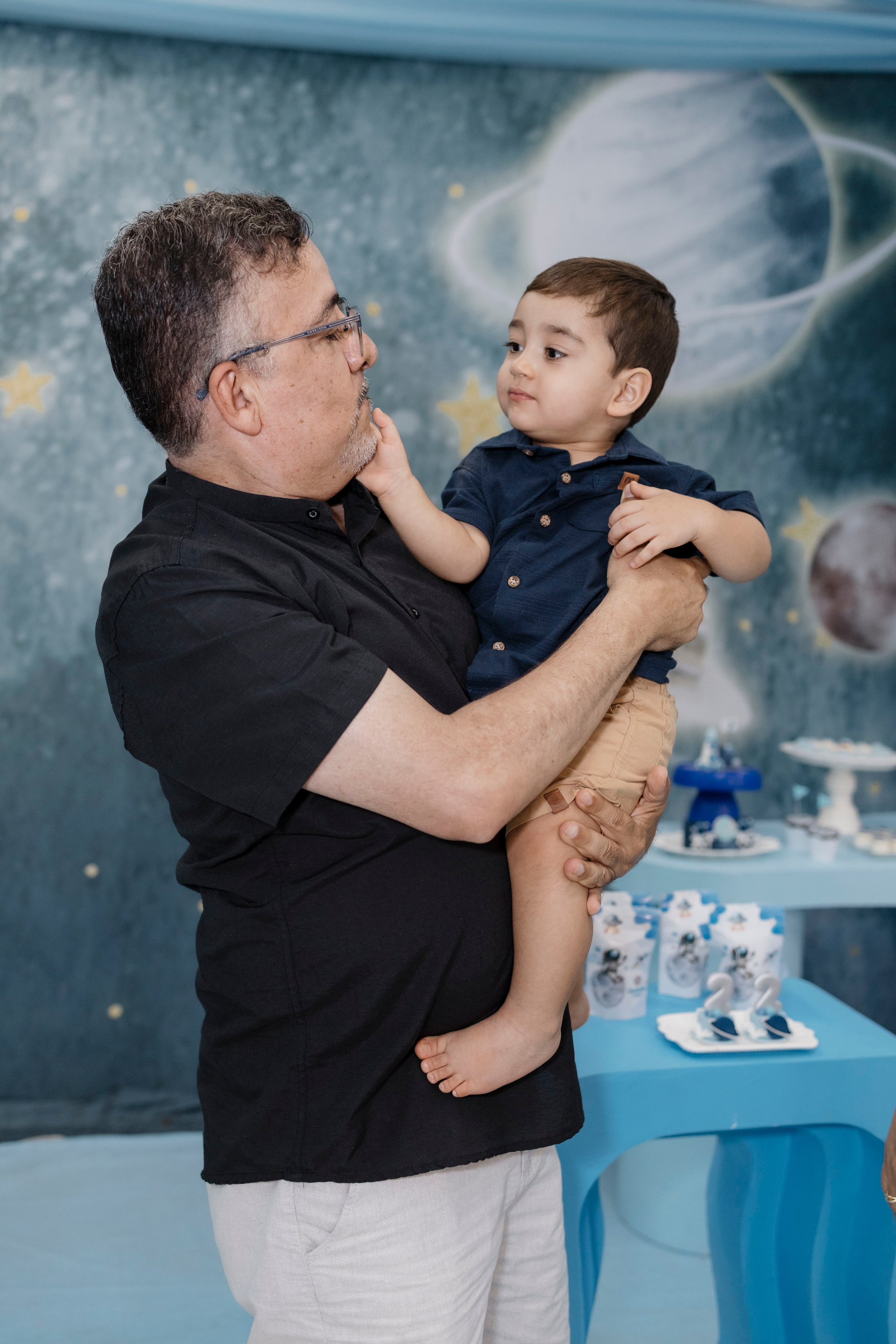 Joaquim no colo da família durante a festa de 2 anos