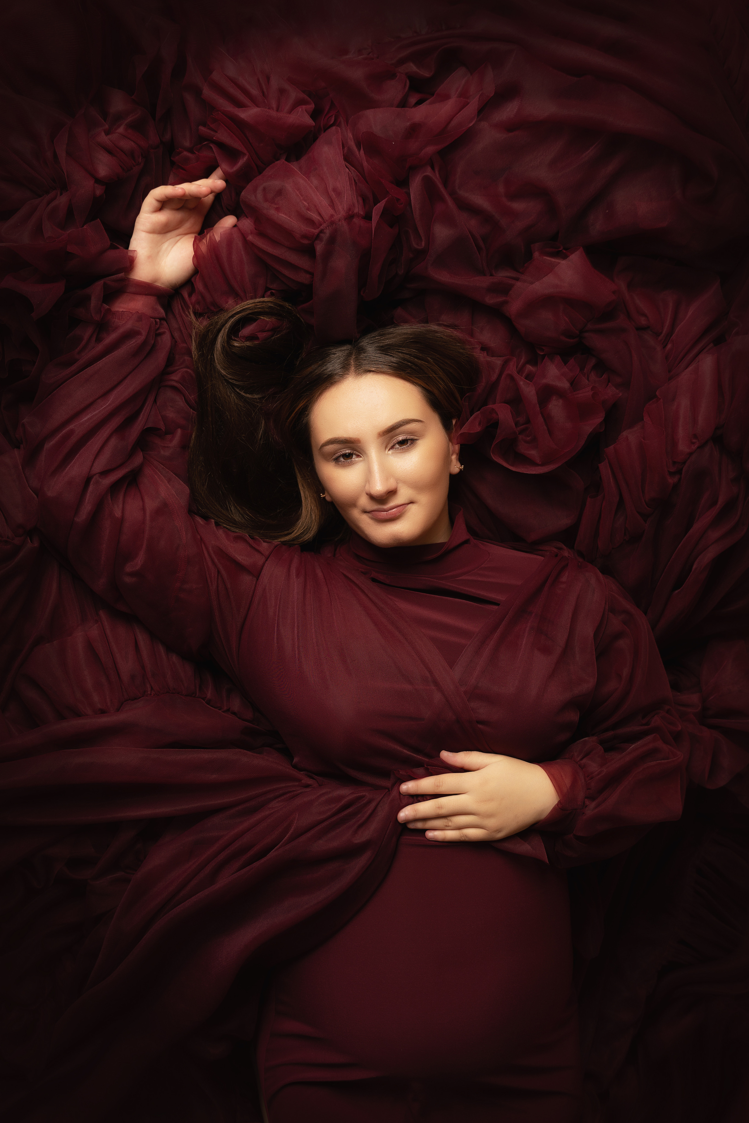 Schwangerschaftsfotografie in einem burgunderfarbenen Kleid