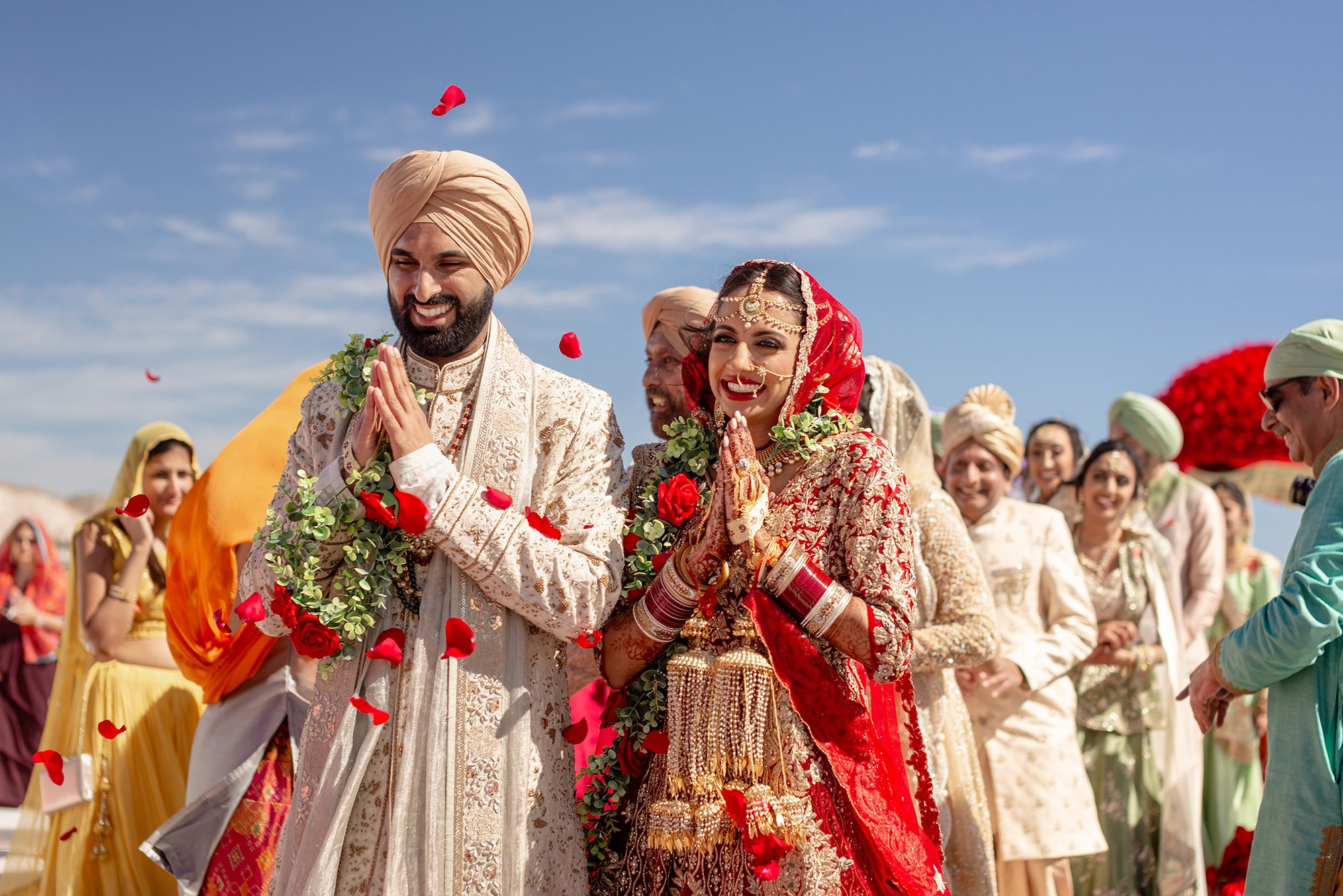Indian wedding ceremony in Los Cabos – bride and groom saying namaste to guests, cultural destination wedding in Baja California Sur