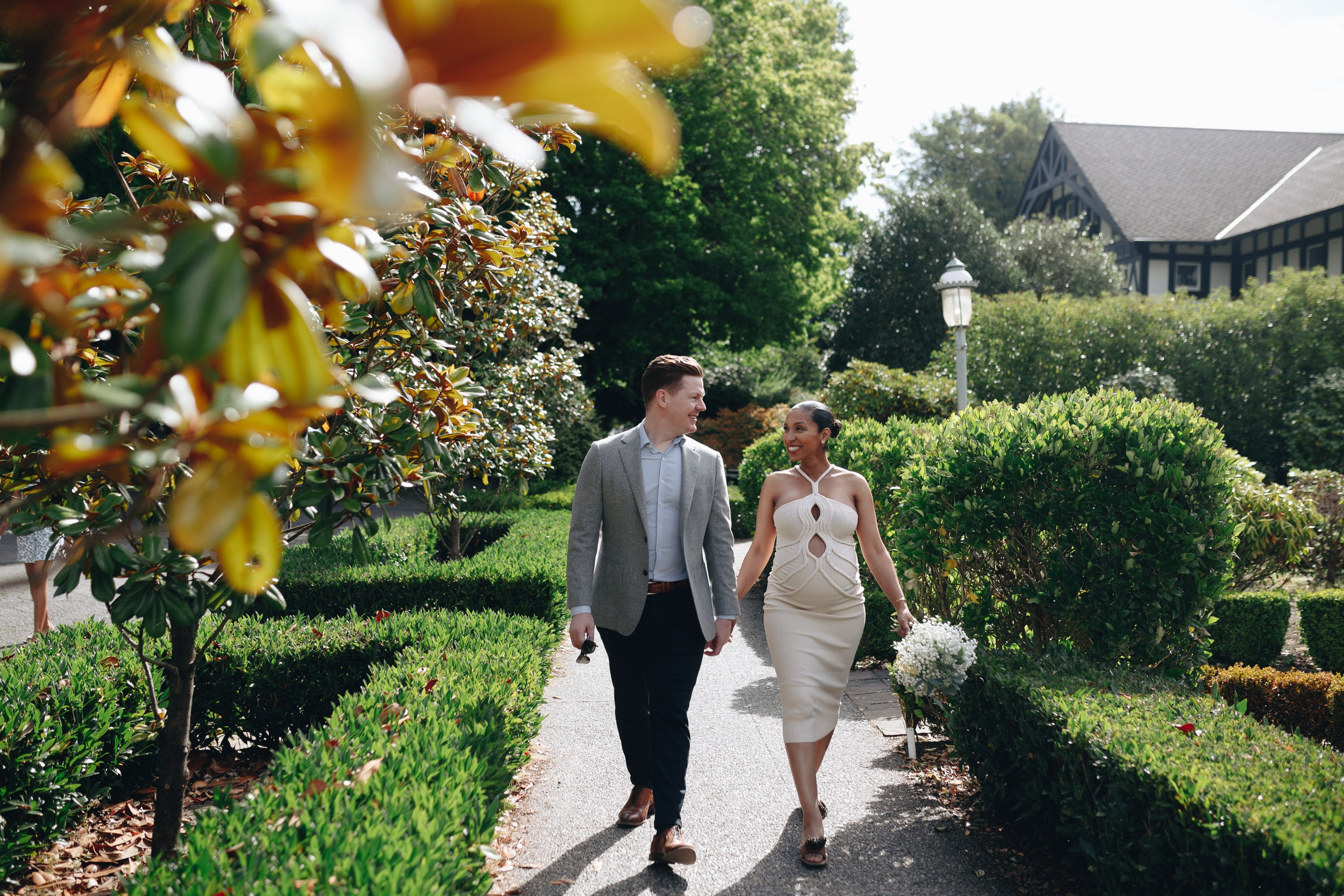 Bride and groom walking in garden, joyful wedding day