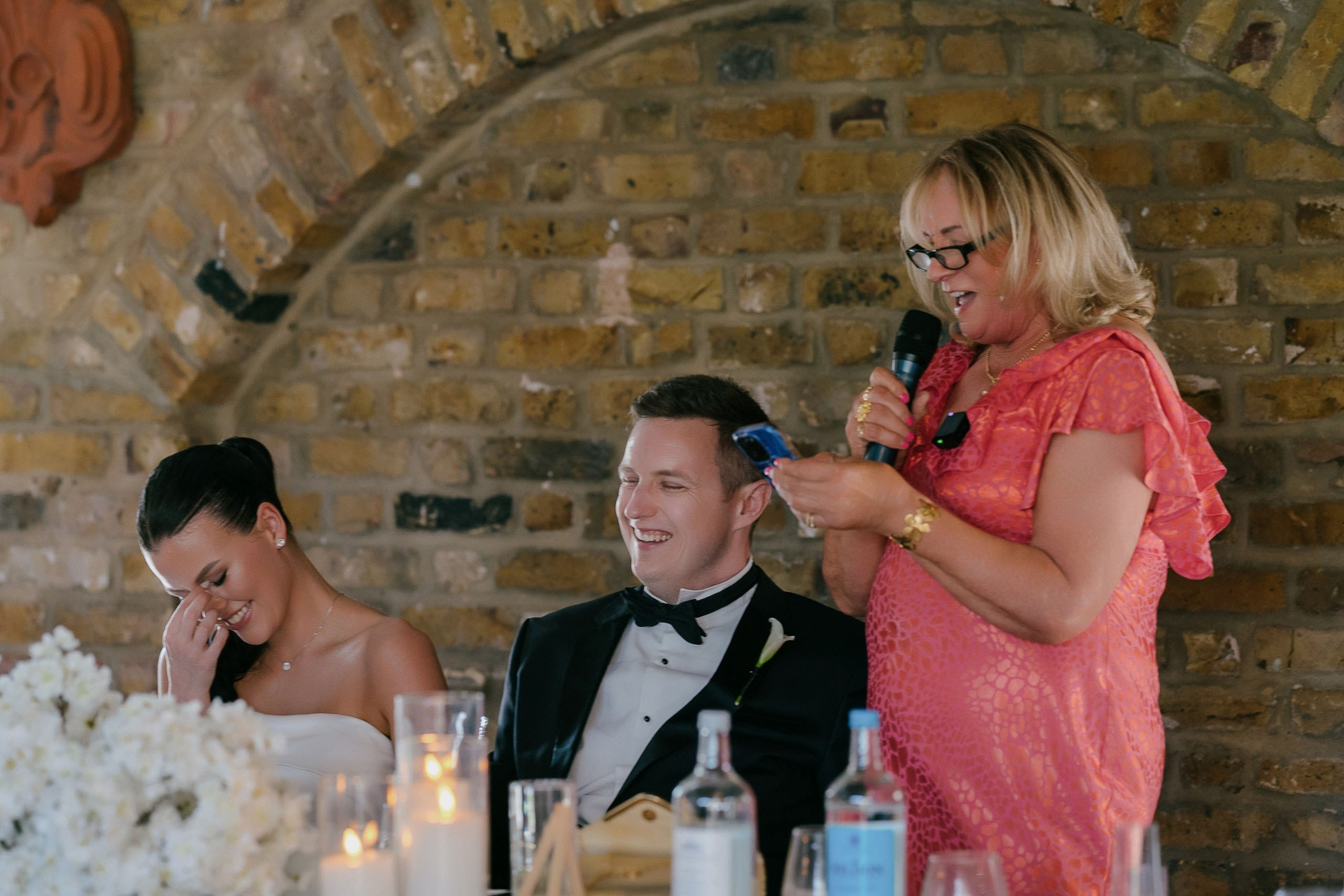 Wedding speech moment emotional reaction bride and groom at table