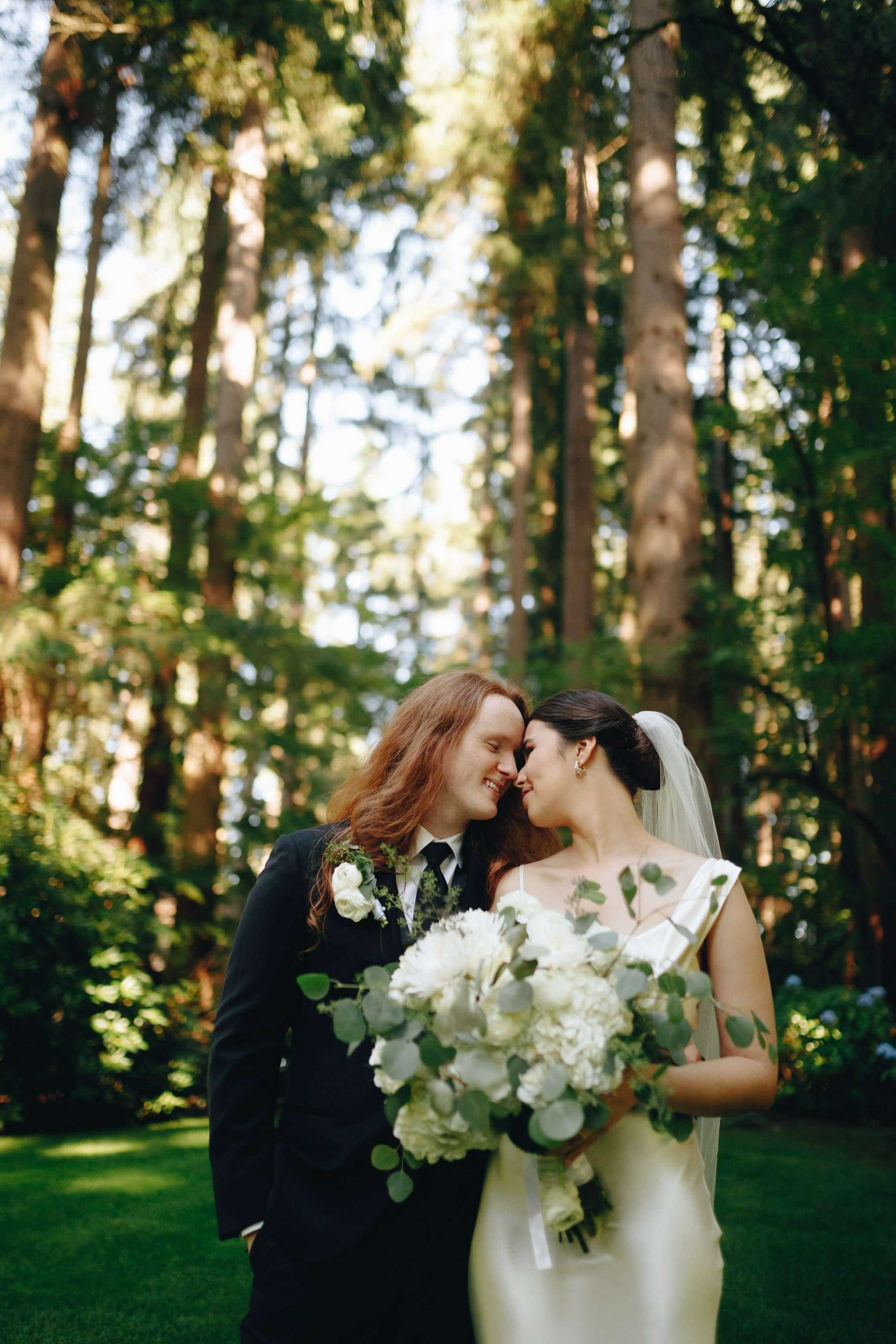 Bride holding bouquet in forest, natural wedding moment