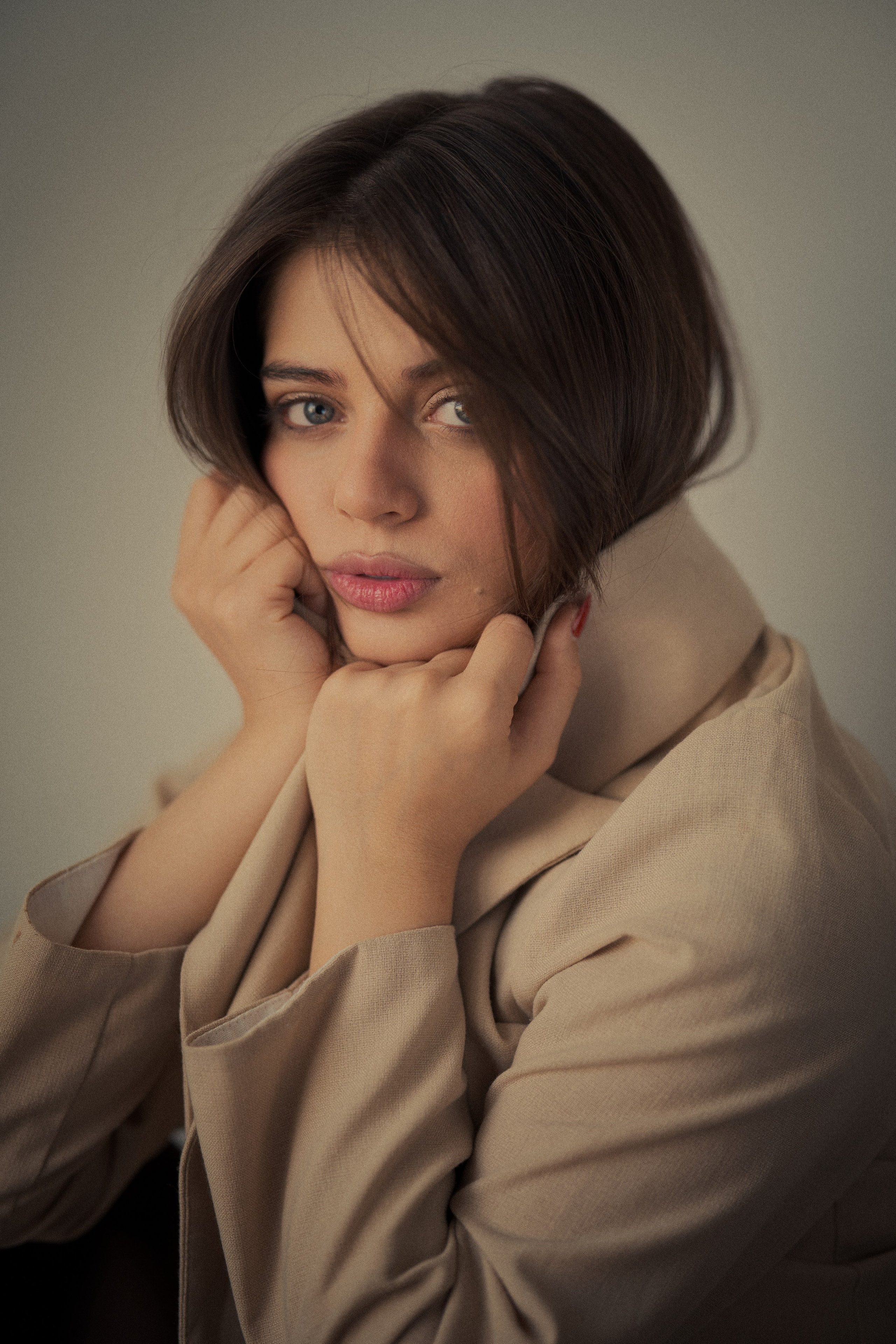 Fine art female portrait photography by Mehran Hadad featuring Forouq Mohamadi wrapped in a beige blazer with soft hair framing her face.