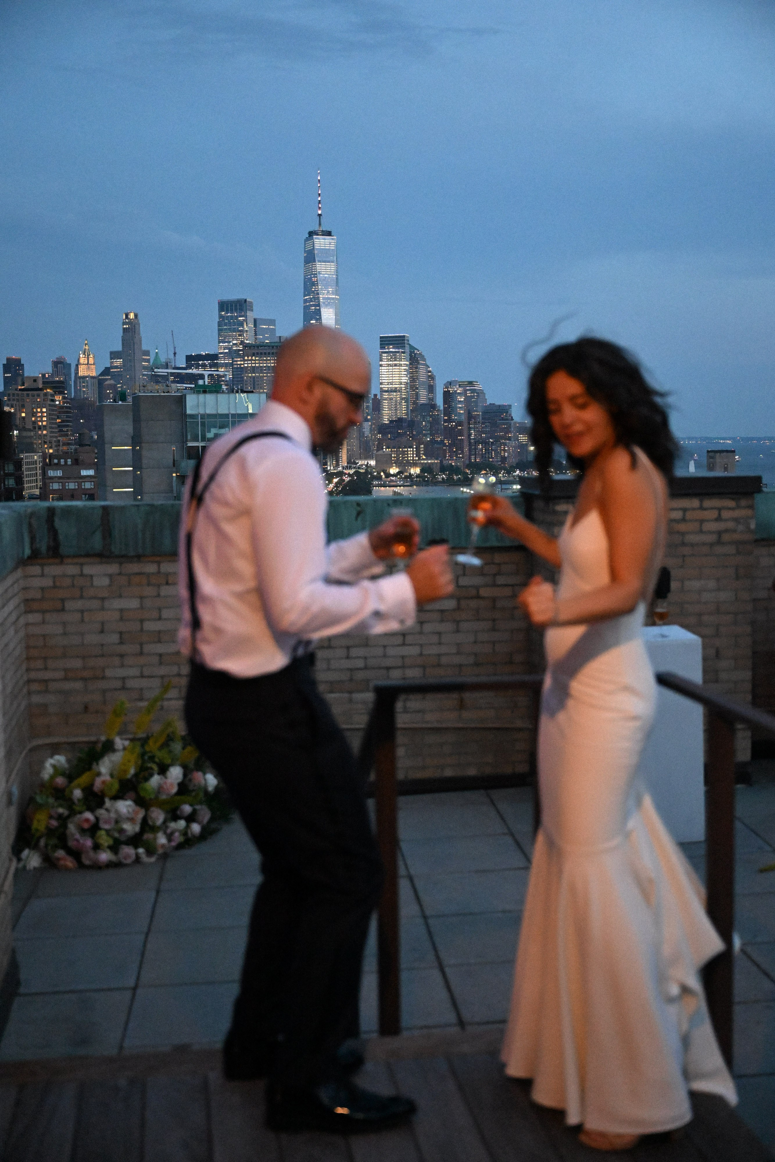 a man and woman are standing on a rooftop