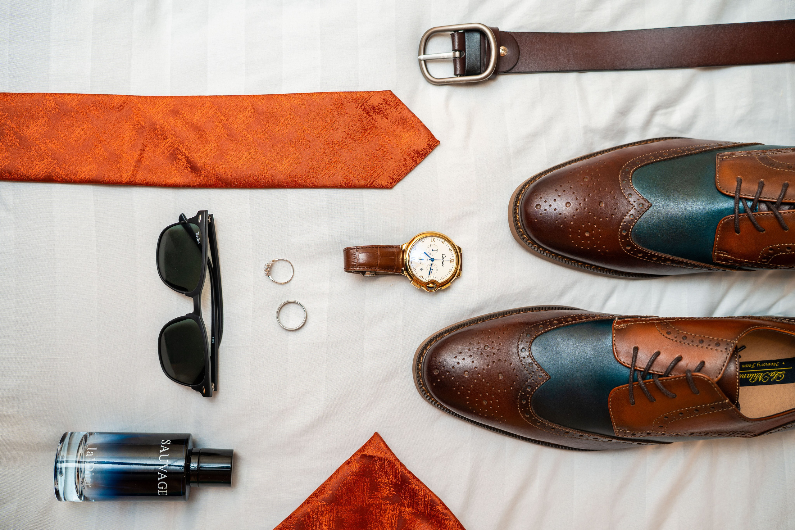 Vibrant detail shot of a groom's shoes and accessories. Best wedding photography