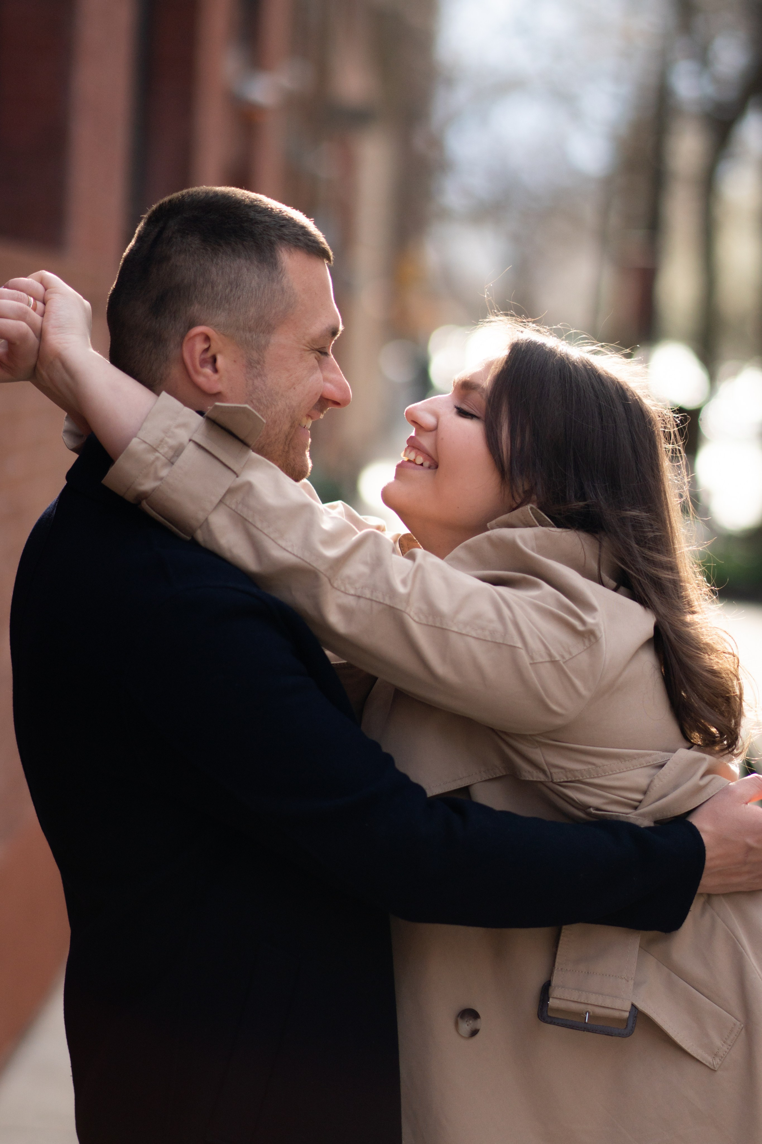 Stylish couple posing in front of a brownstone in the West Village. Description: West Village engagement photographer. capturing the charm of historic brownstones and tree-lined streets.