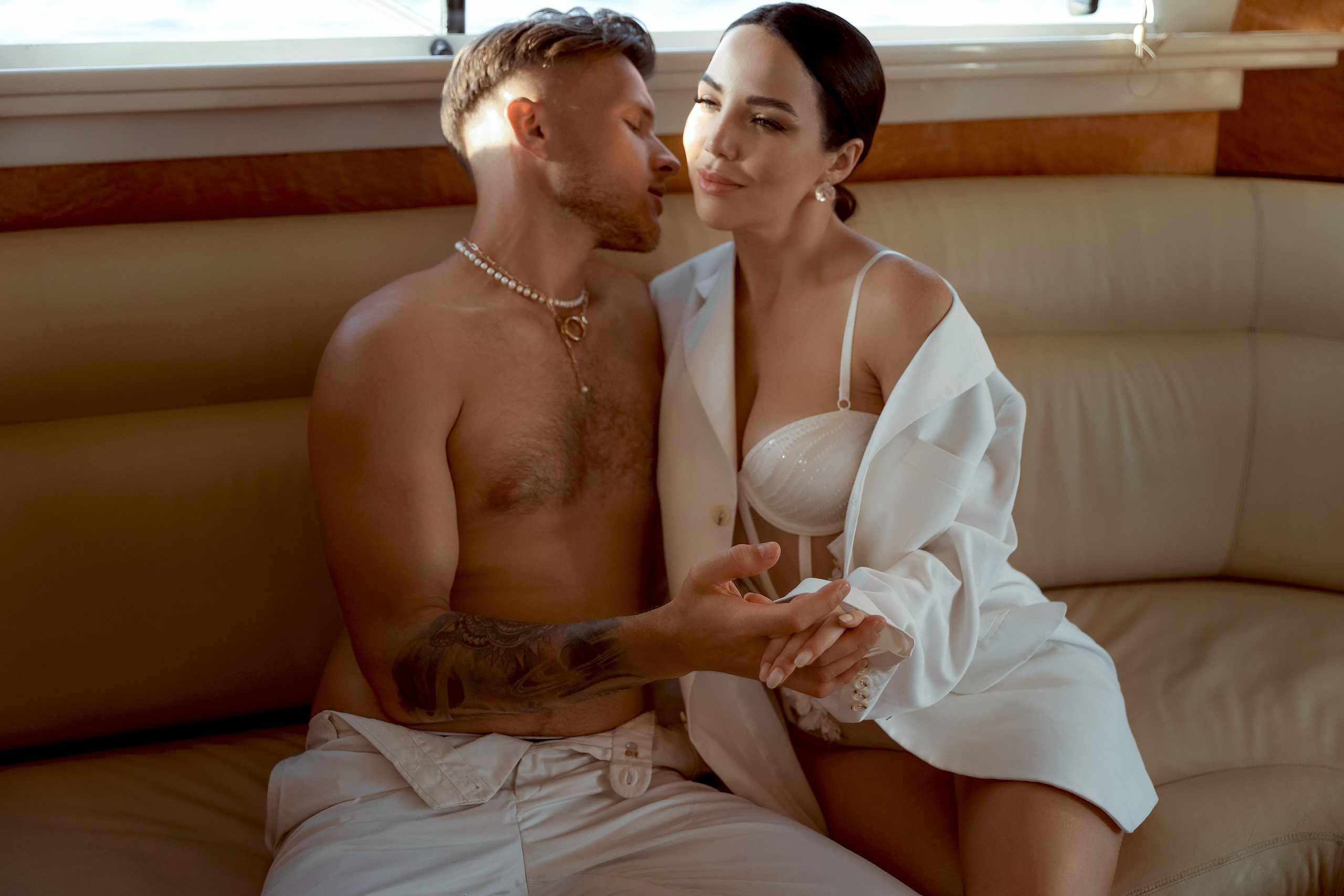 A couple’s love story told through portraits on a yacht: together, they share an embrace. Dubai, United Arab Emirates