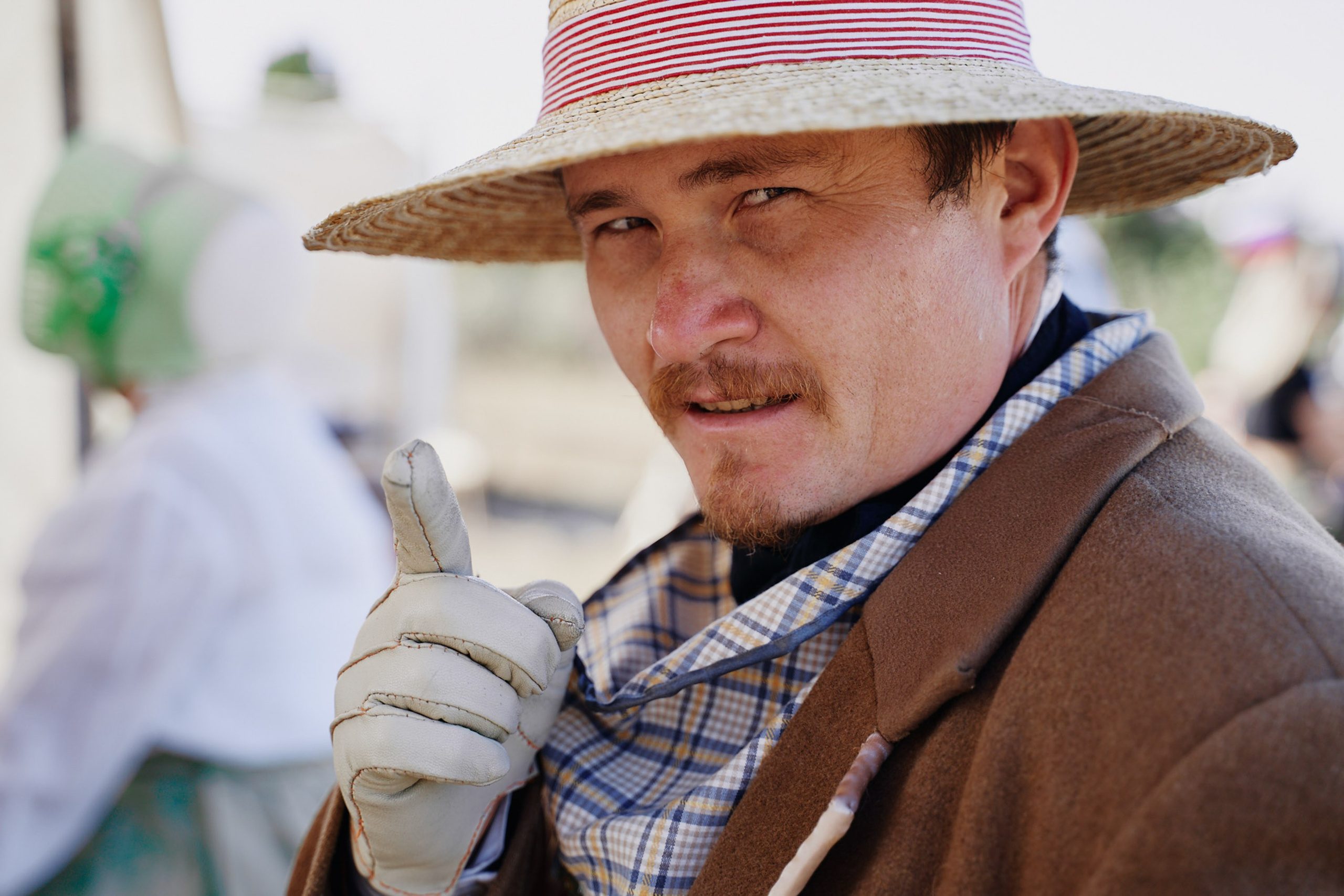 Portrait of man in hat with scarf outdoors