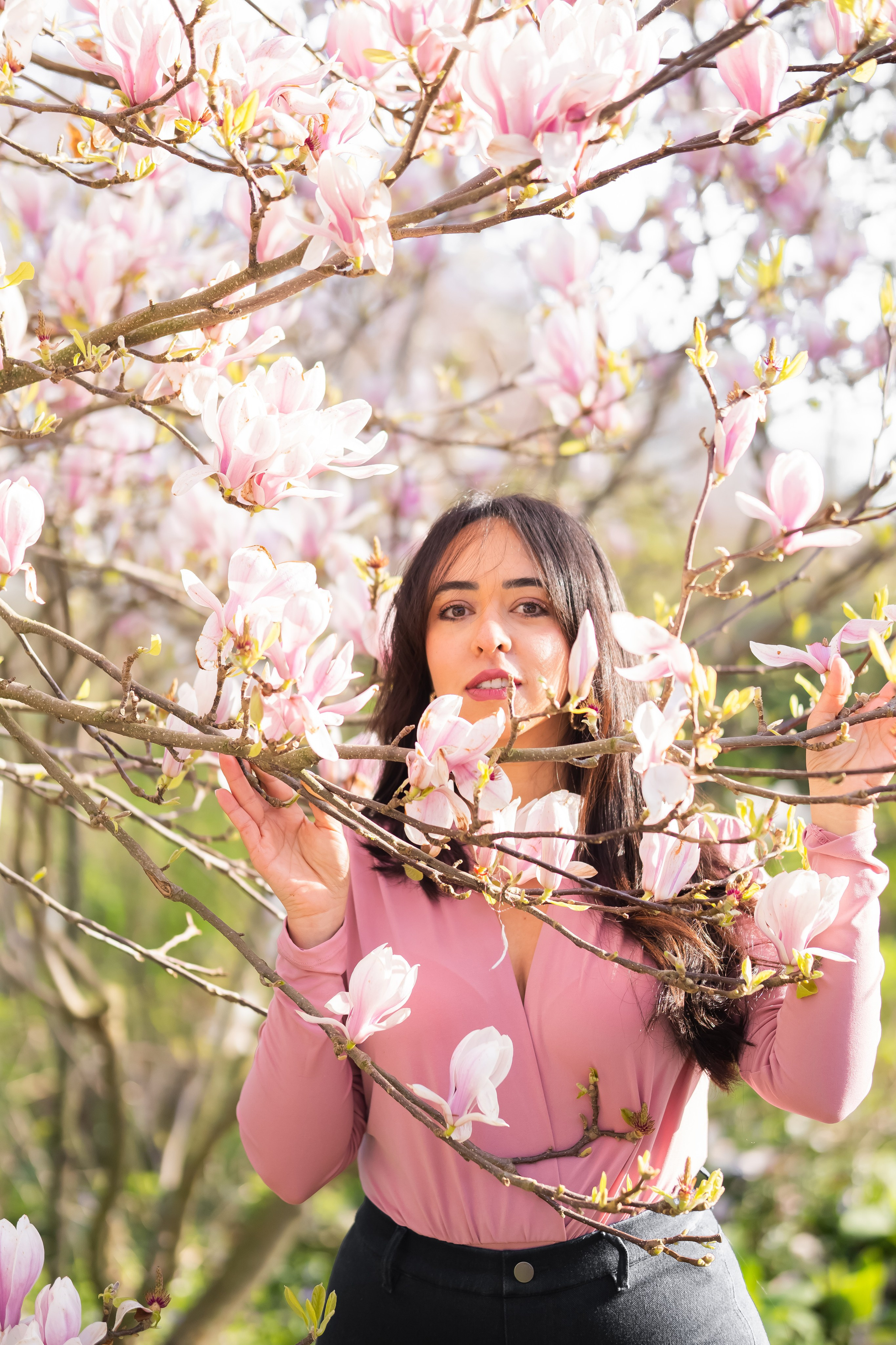 girl standing in a cherry blossoms garden in Netherlands
