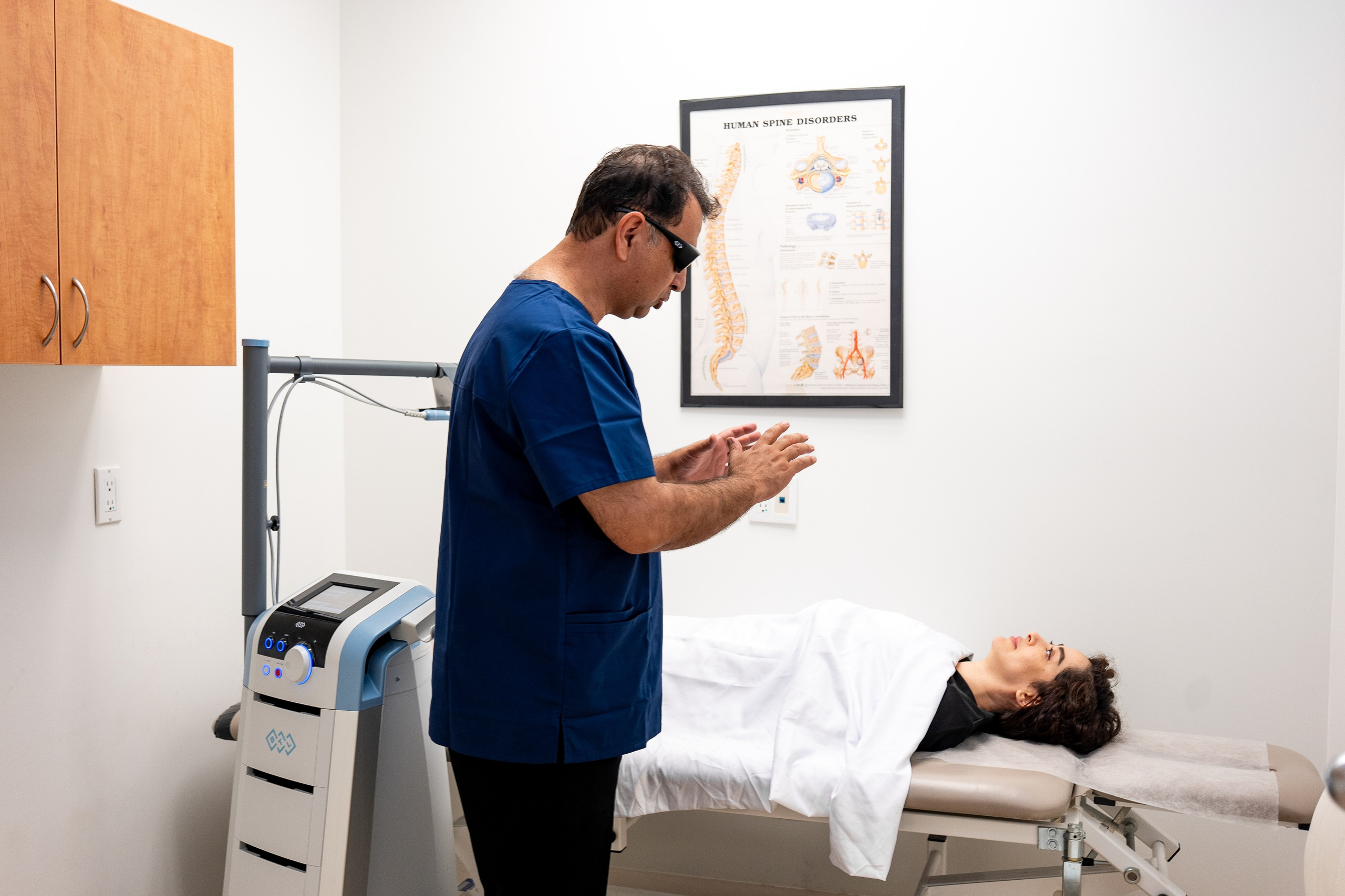 Doctor performing laser treatment on patient