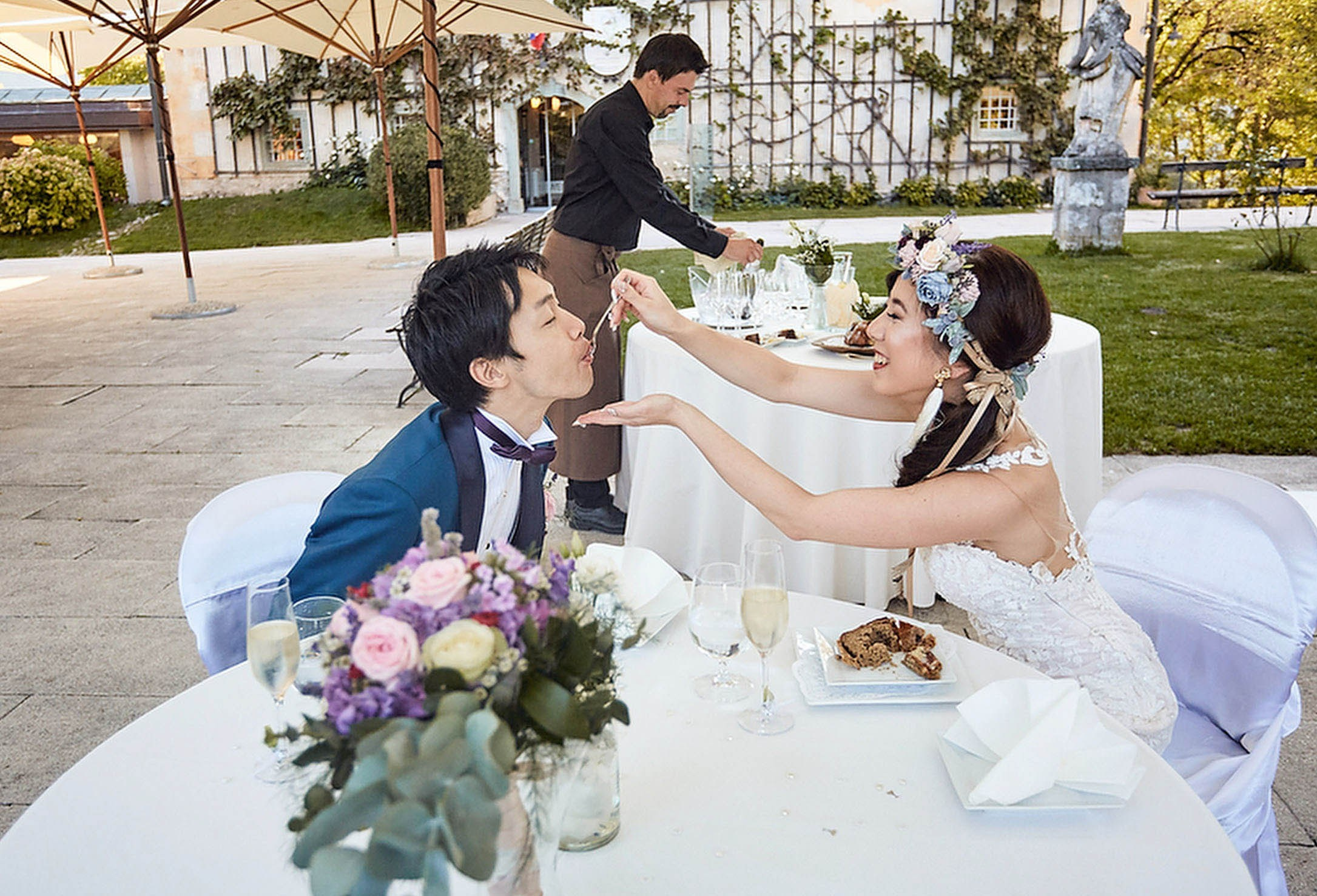 Bride feeds wedding cake to her groom.