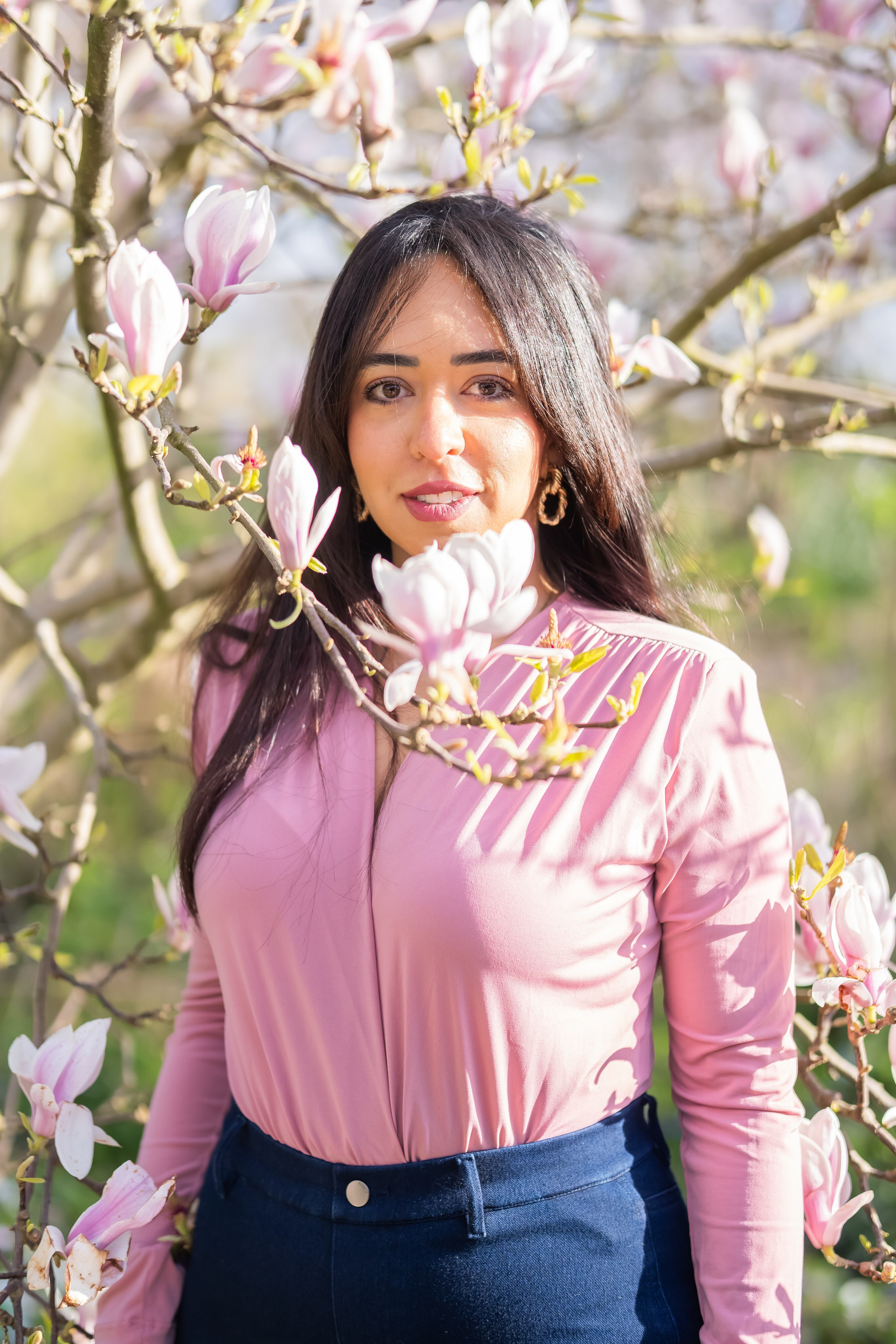 girl standing in a cherry blossoms garden in Netherlands