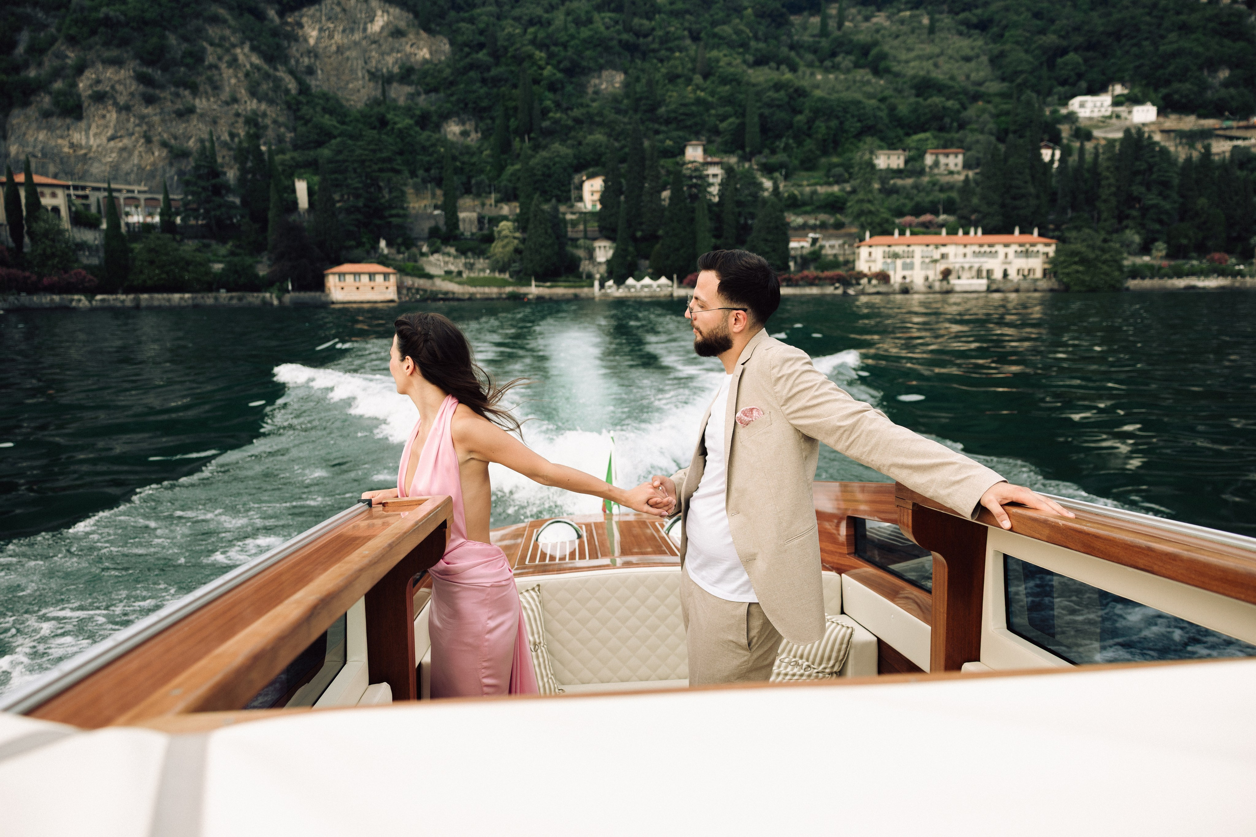 Couple celebrating their surprise engagement surrounded by the beauty of Lake Como