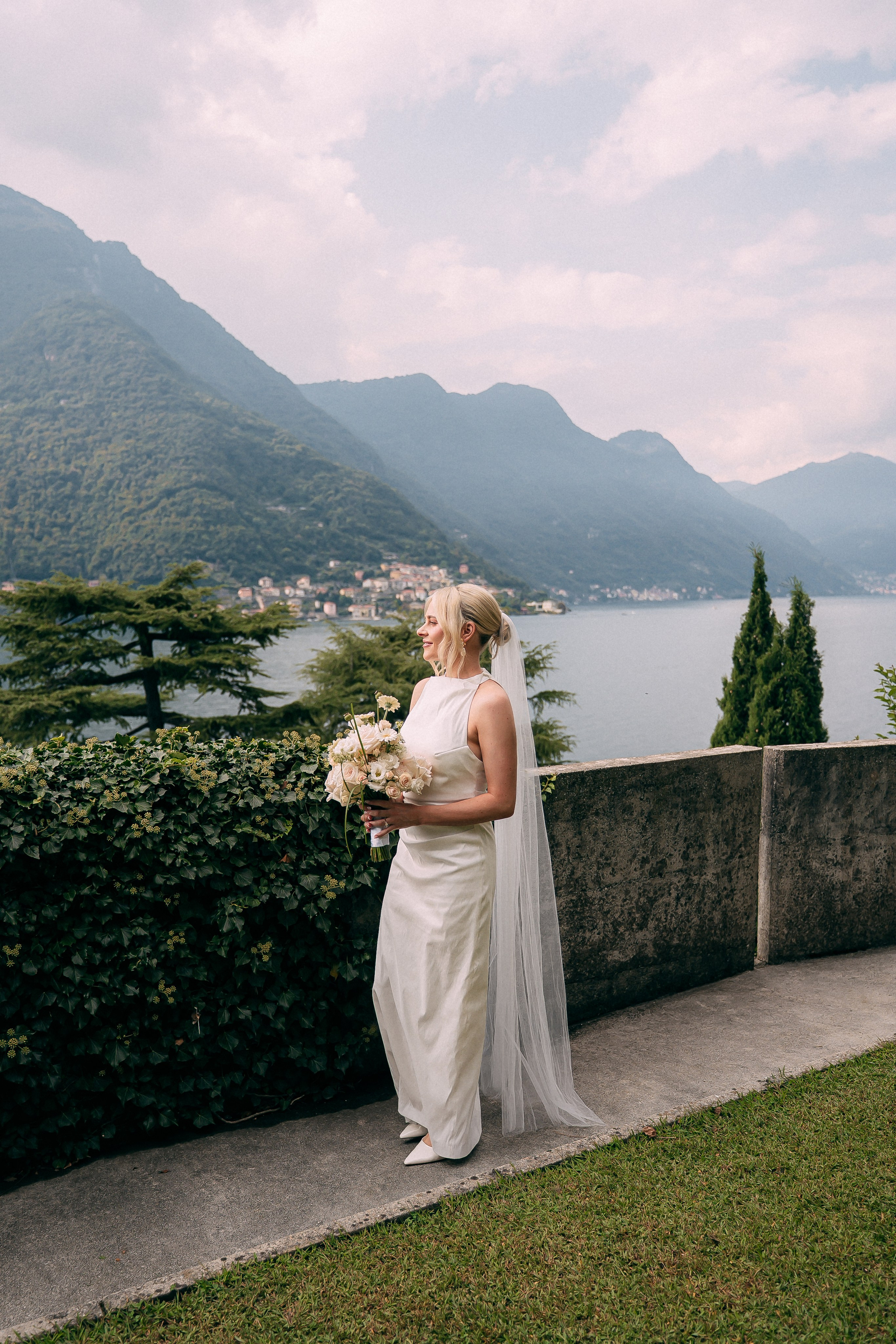 Bride holding her bouquet on the balcony at Villa Lario, Lake Como, Italy