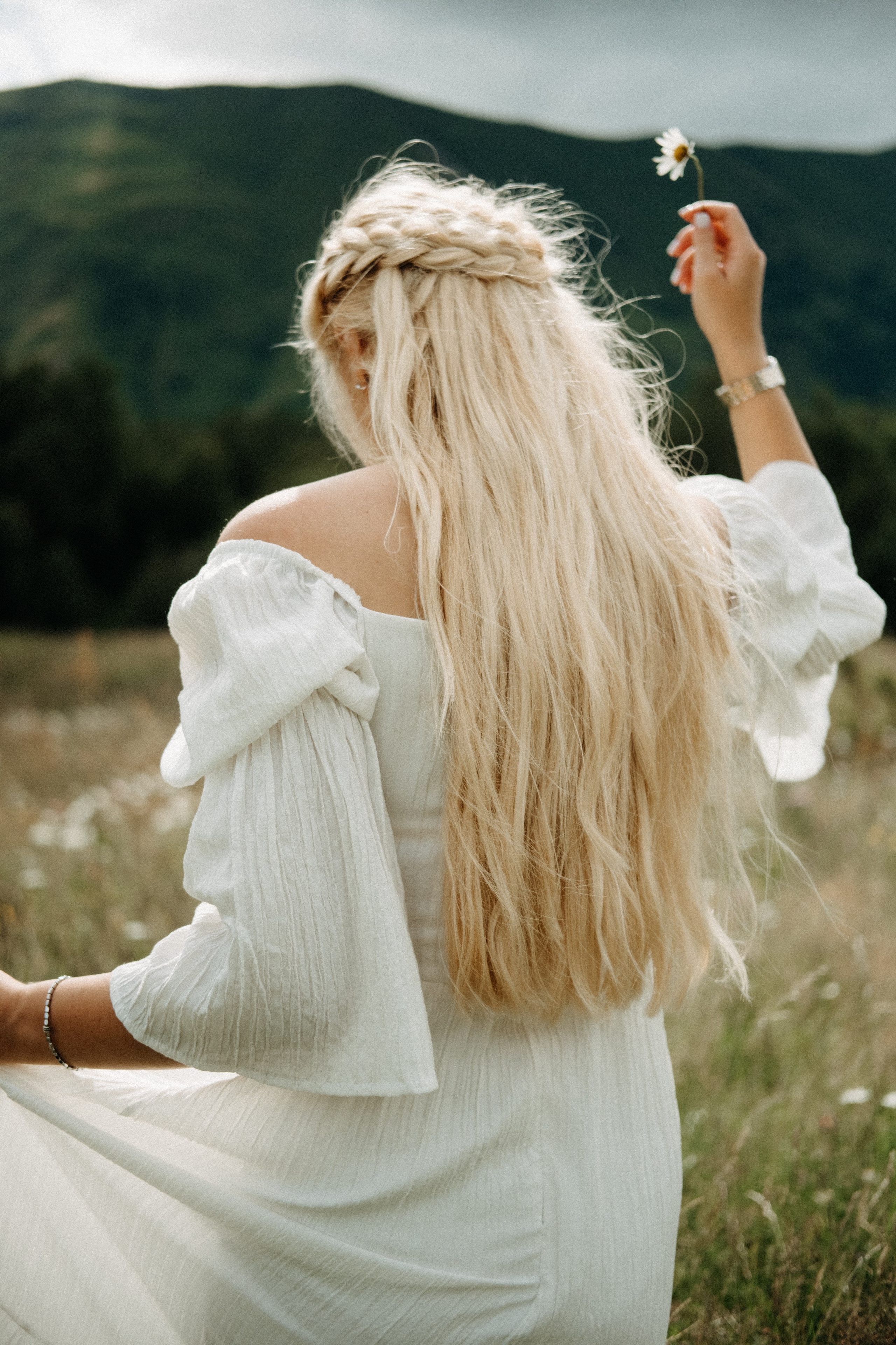 Back view woman with long hair in mountains