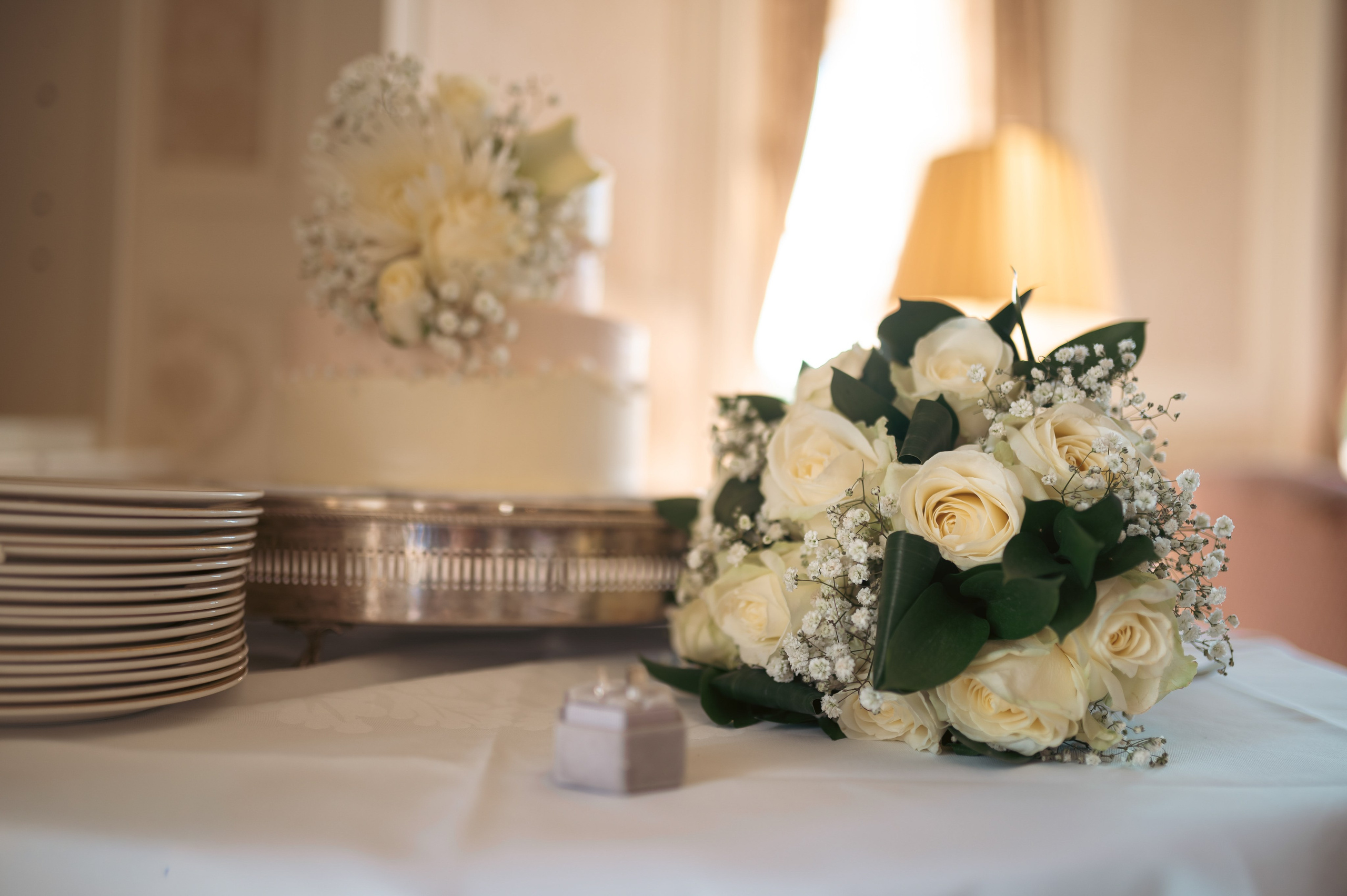 Bride and groom embracing indoors at Luton Hoo, warm evening light