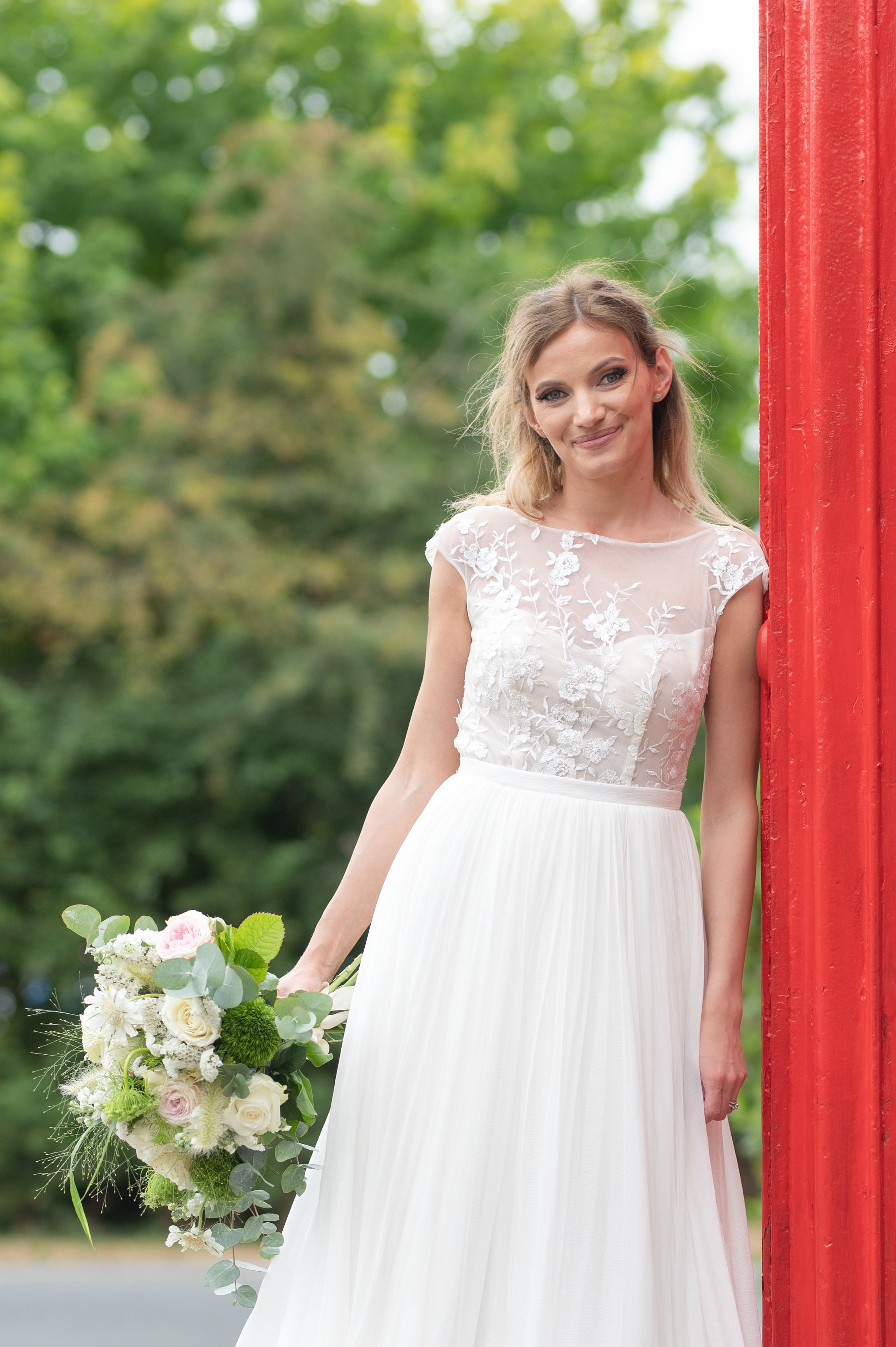 Close bridal portrait by the red phone box, natural light