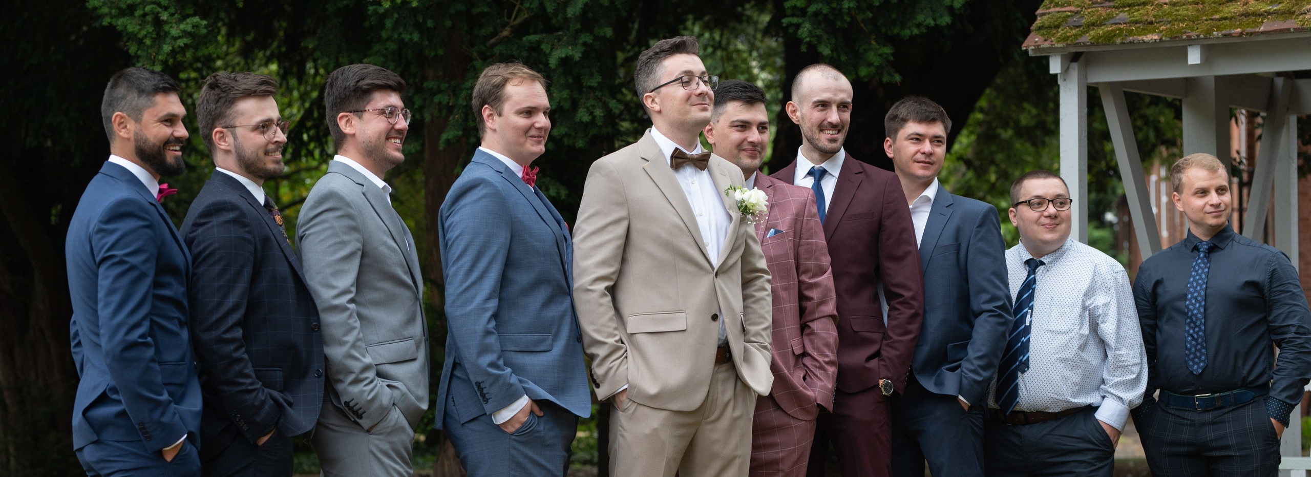 Groom and groomsmen group portrait in mixed navy, grey and burgundy suits at Charlecote Pheasant Hotel