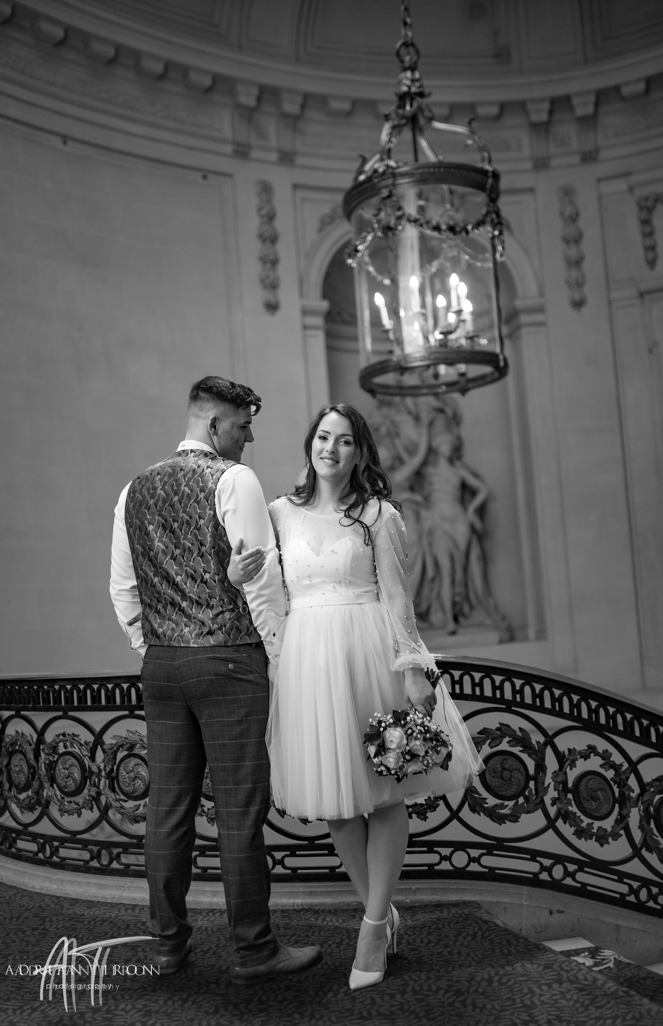 Bride and groom sharing a close moment on the staircase at Luton Hoo, black and white