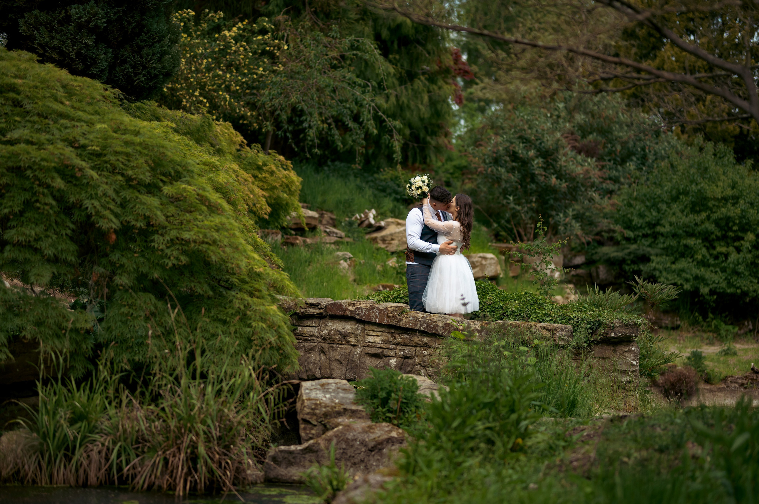 Flower girl in a white dress on the grounds of Luton Hoo