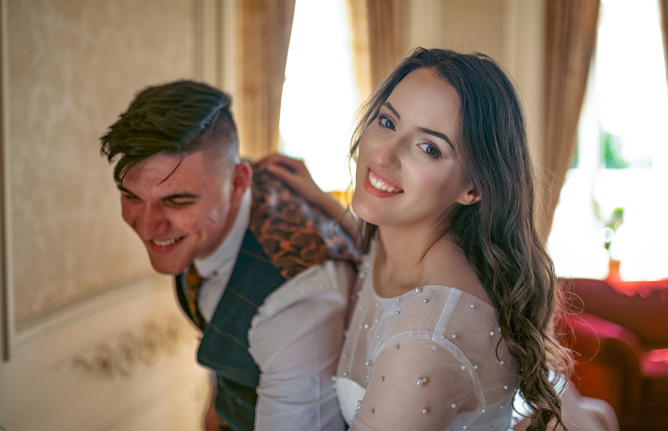 Bride and groom sharing an embrace on a garden path at Luton Hoo