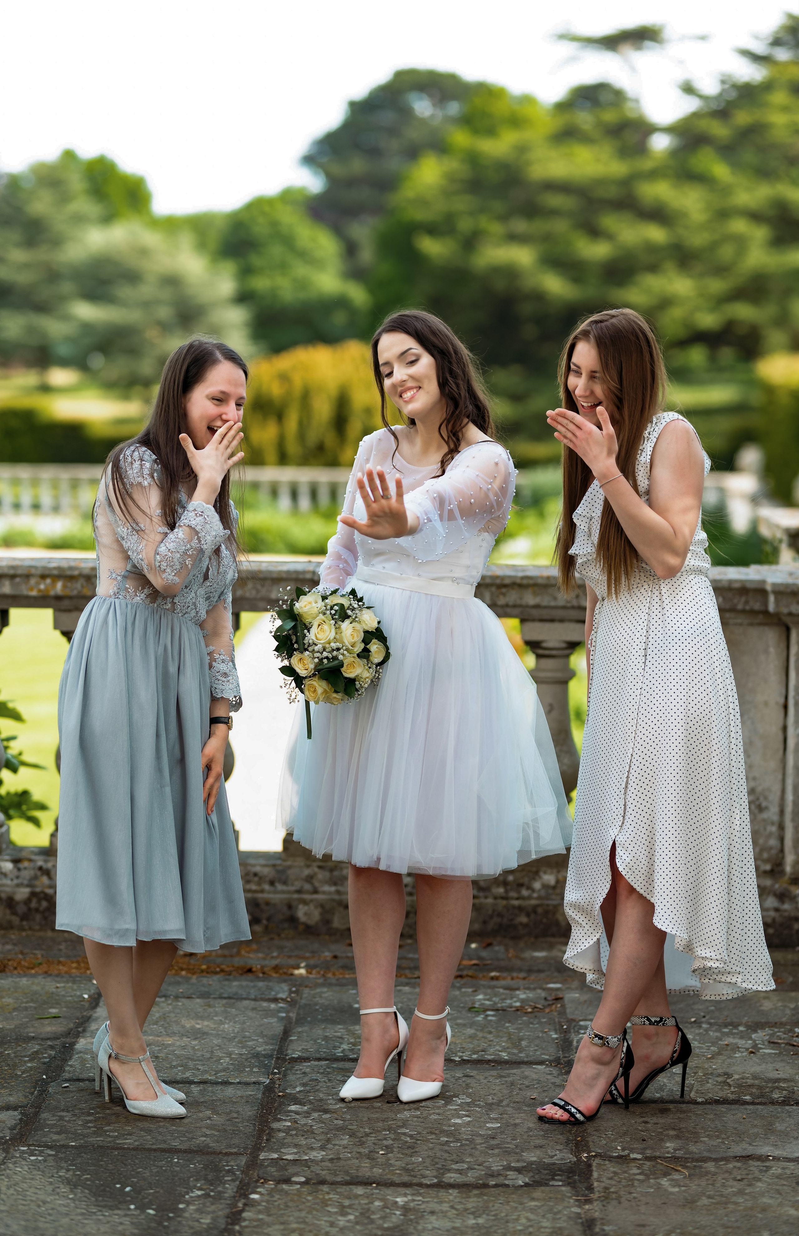 Bride laughing with her bridesmaids at Luton Hoo, Bedfordshire