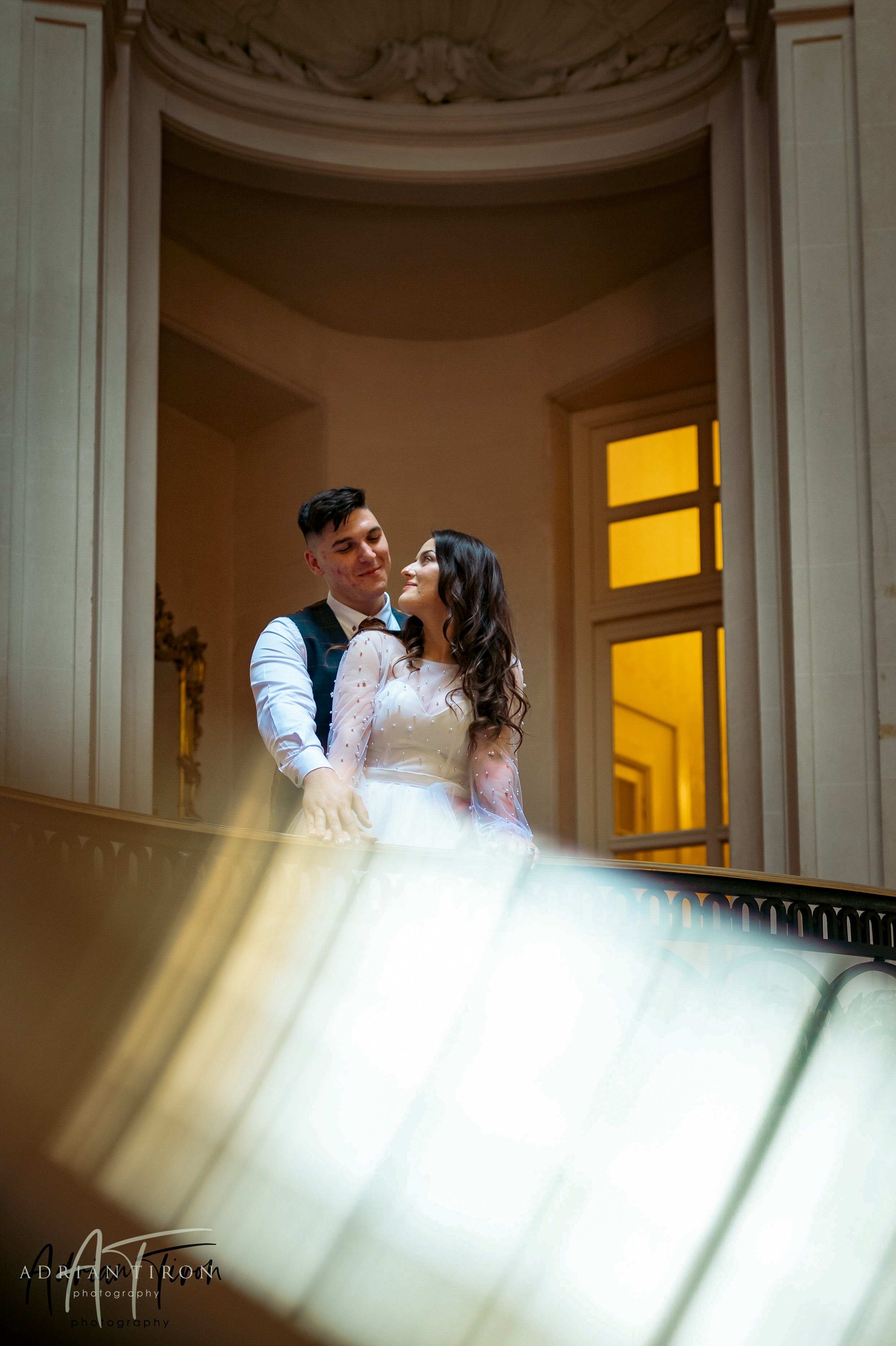 Bride and groom embracing in a warmly lit doorway at Luton Hoo
