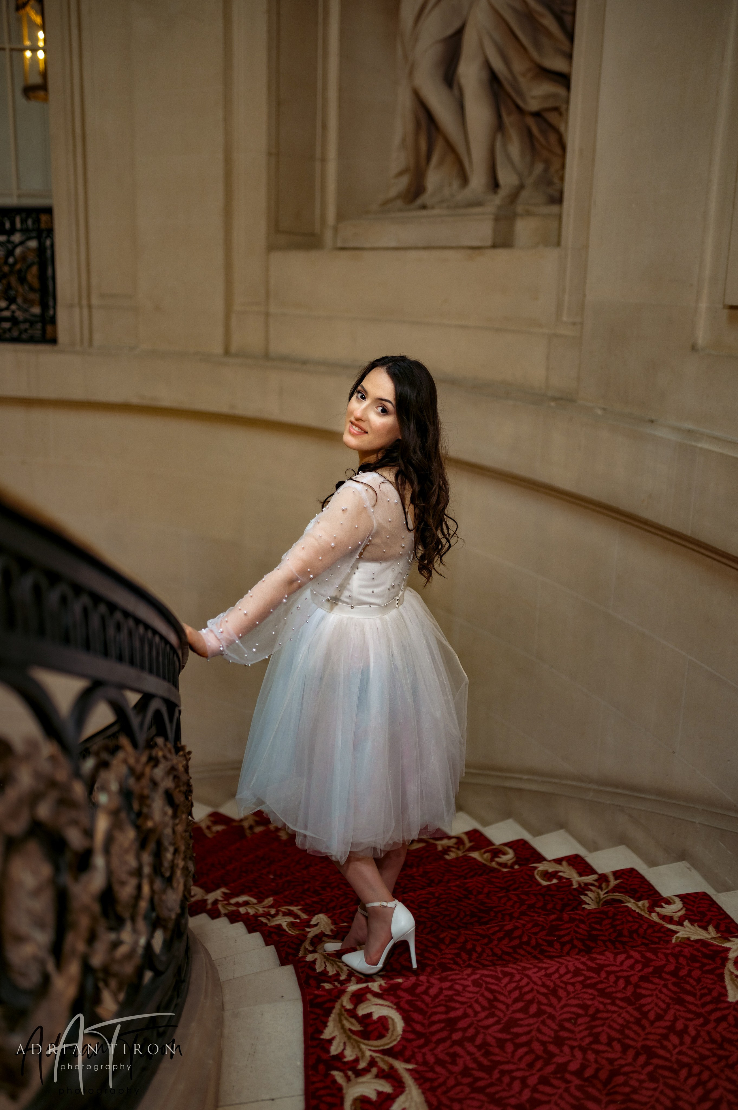 Bride posing on the grand staircase at Luton Hoo