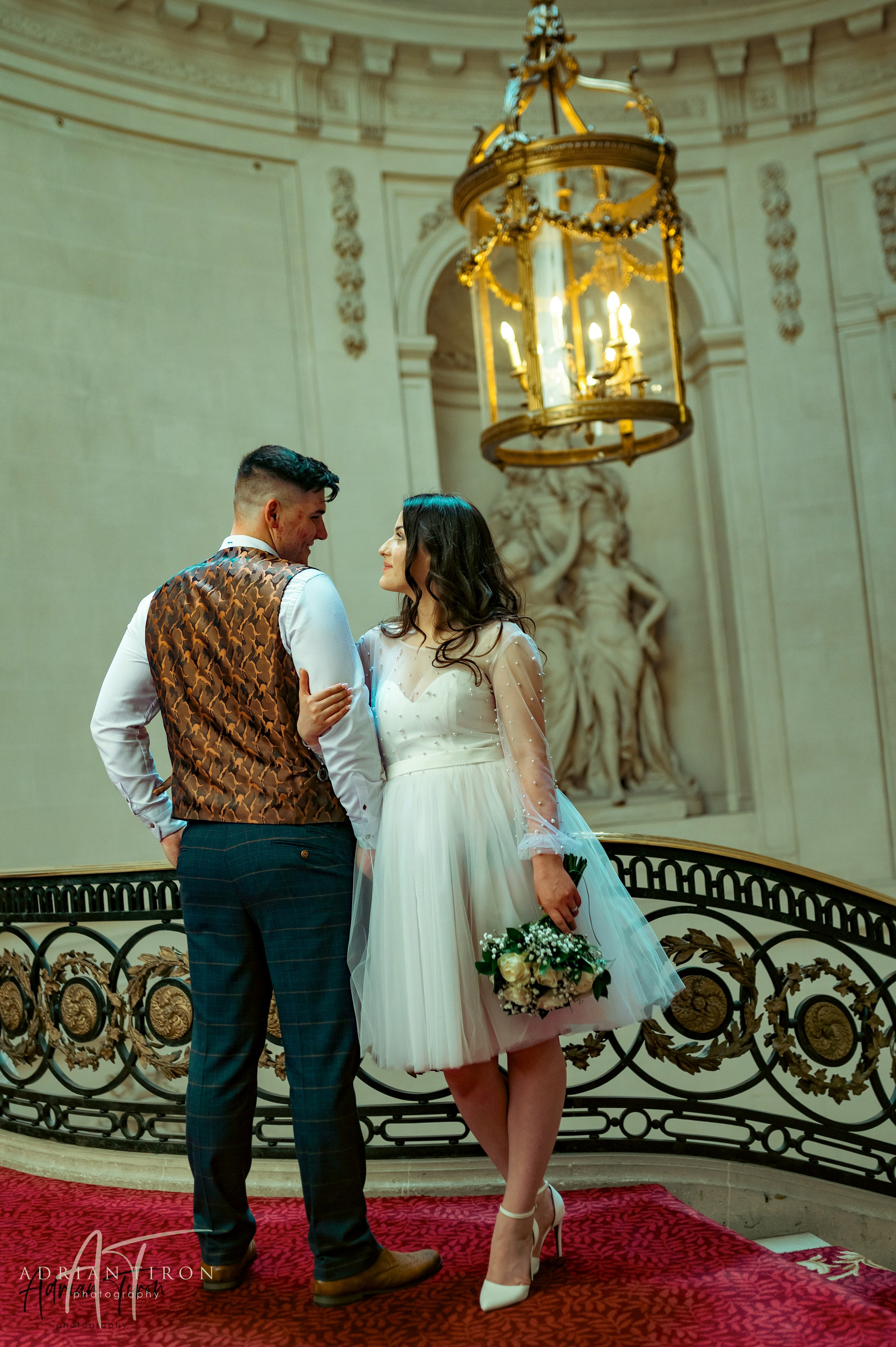 Bride and groom embracing in a gilded doorway at Luton Hoo