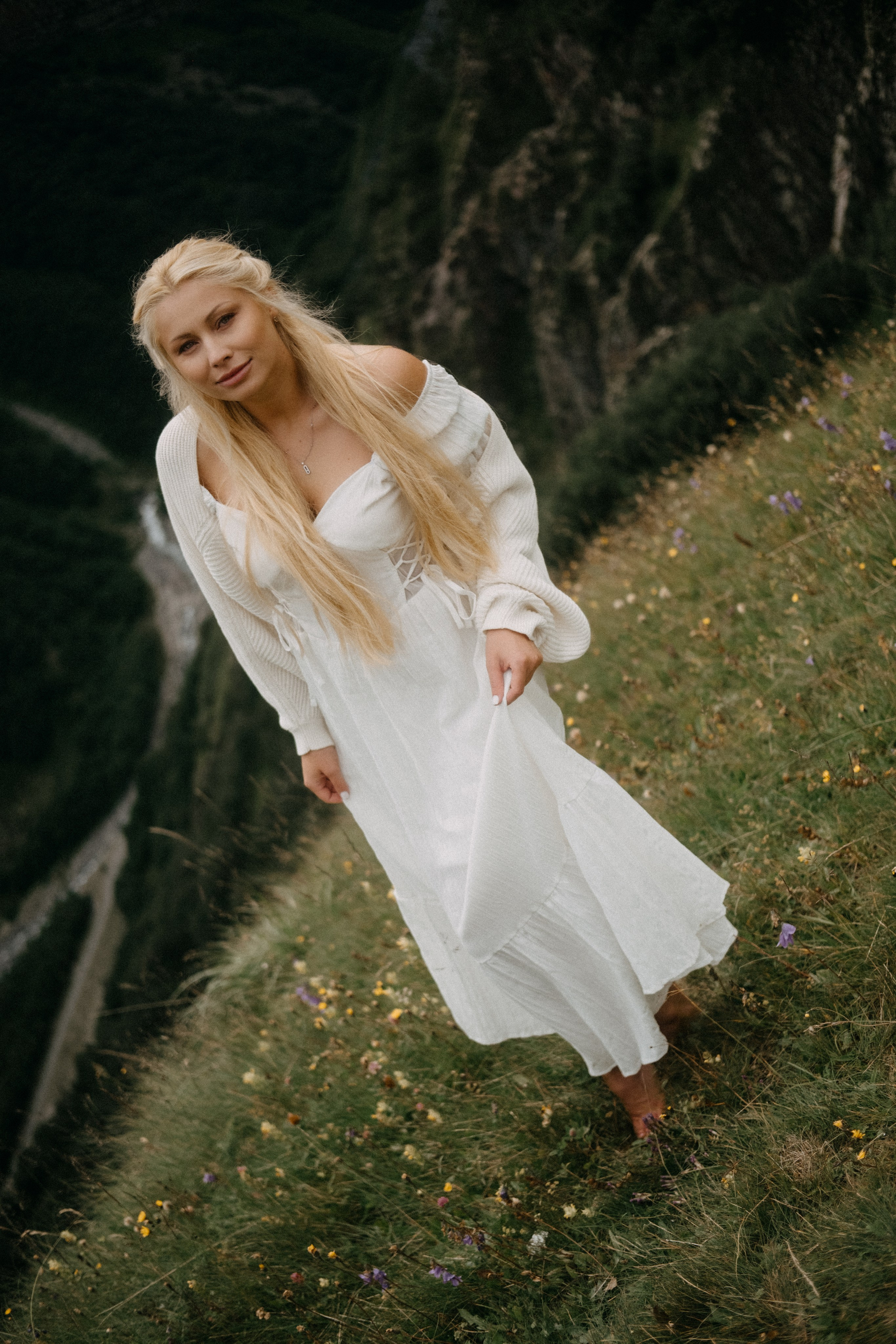 Woman walking along narrow mountain trail
