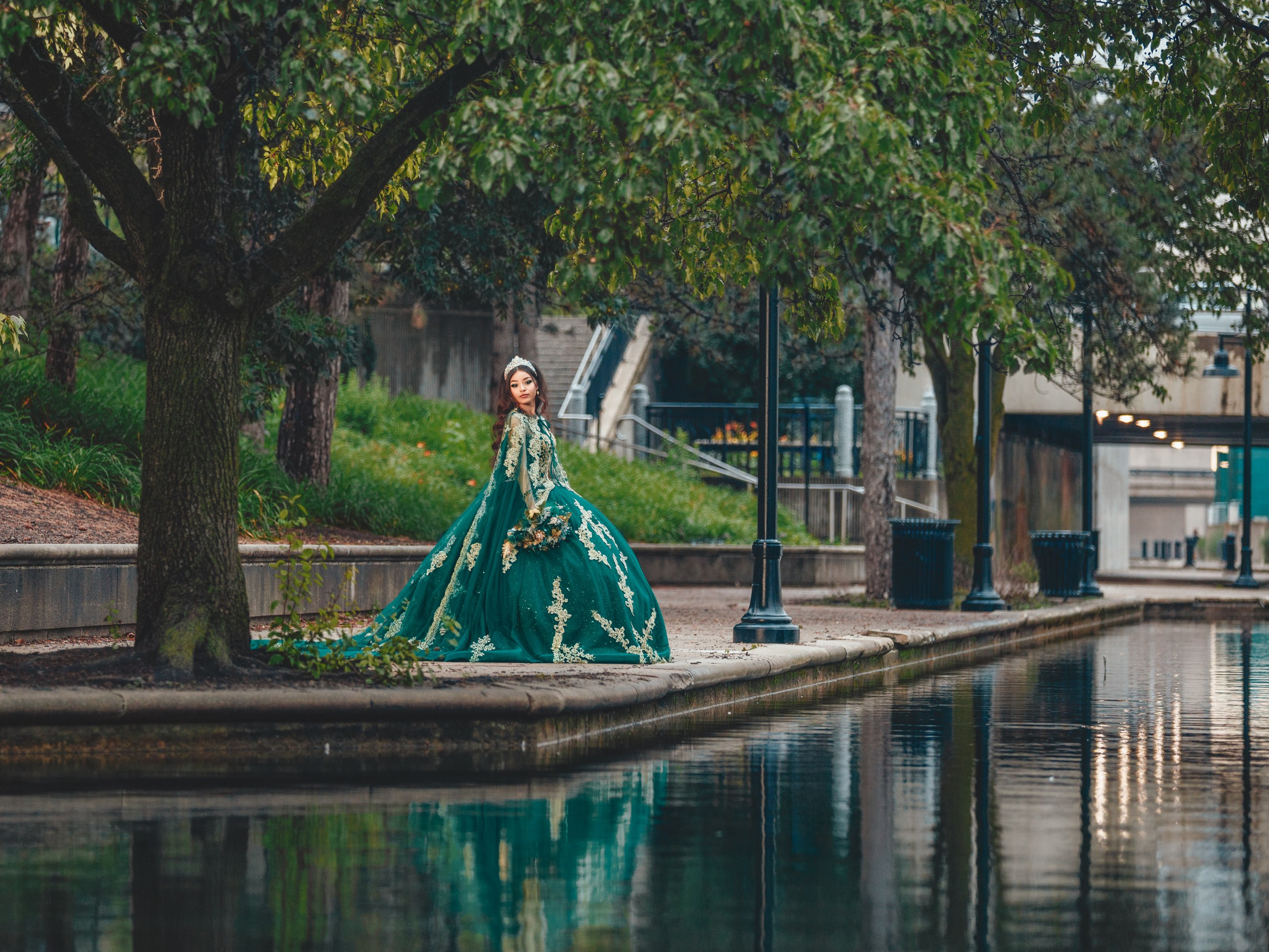 Quinceañera photoshoot at Indianapolis Canal Walk with dramatic reflection and lush green landscape