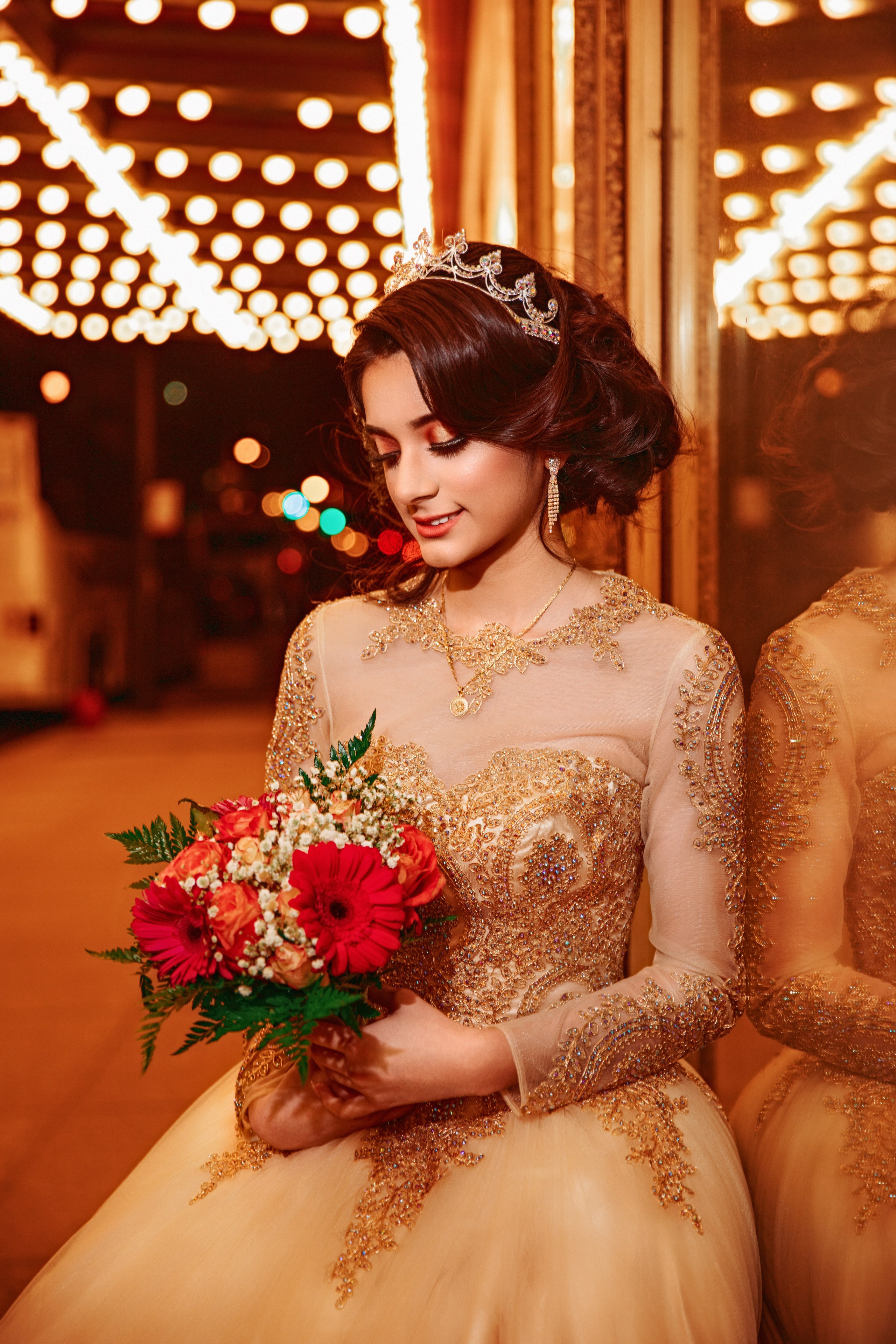 Close-up fine art quinceañera portrait with floral bouquet and warm bokeh lights