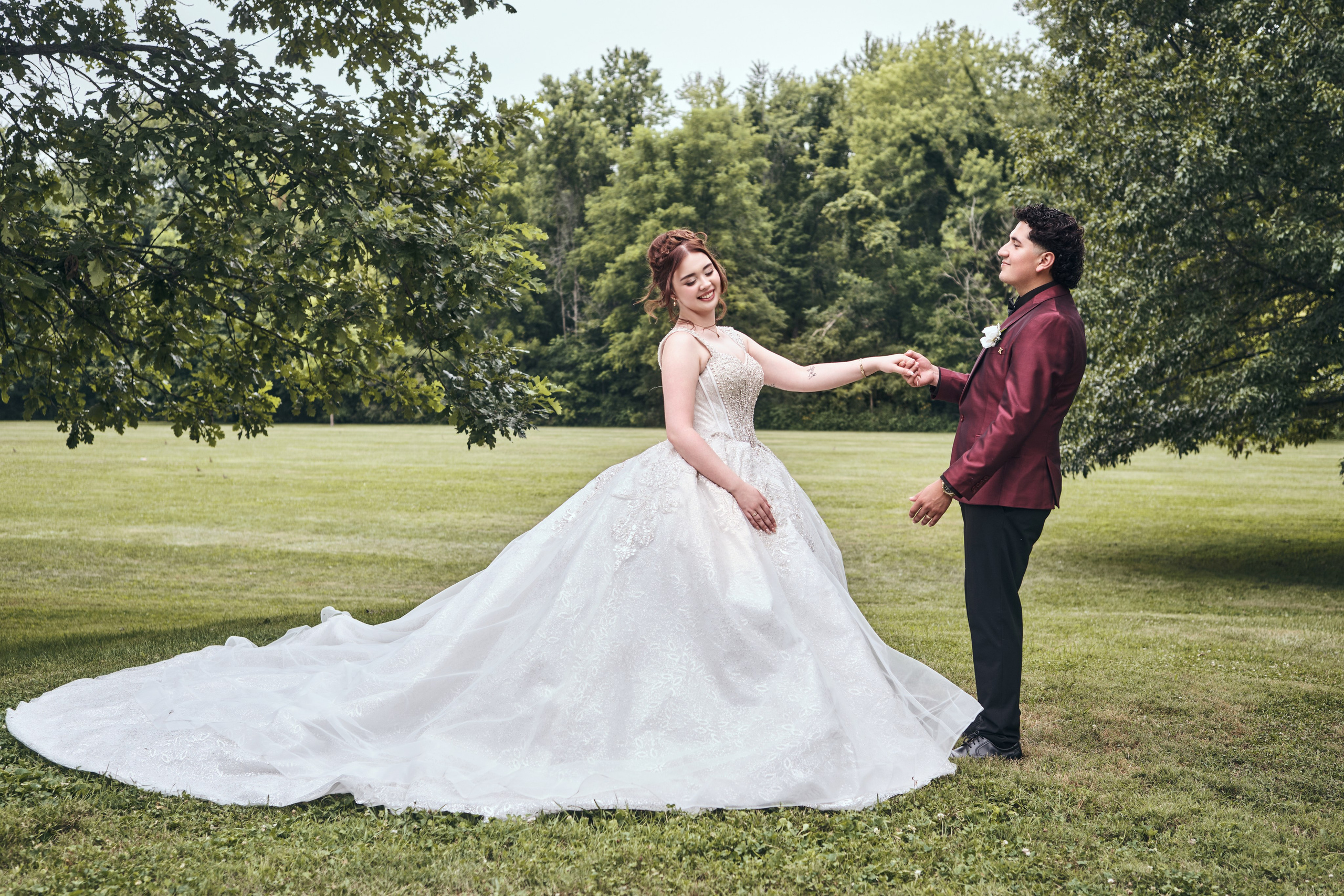 Fine art bride with flowing veil on lush lawn Central Indiana
