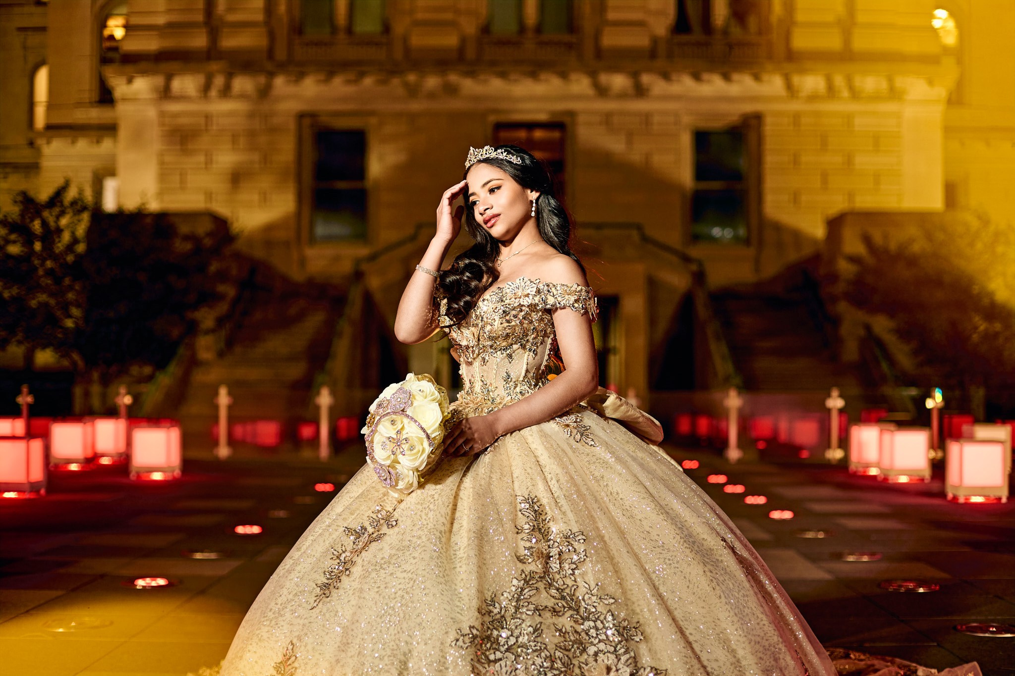Dramatic night quinceañera photoshoot in golden ballgown outside Indiana Statehouse Indianapolis