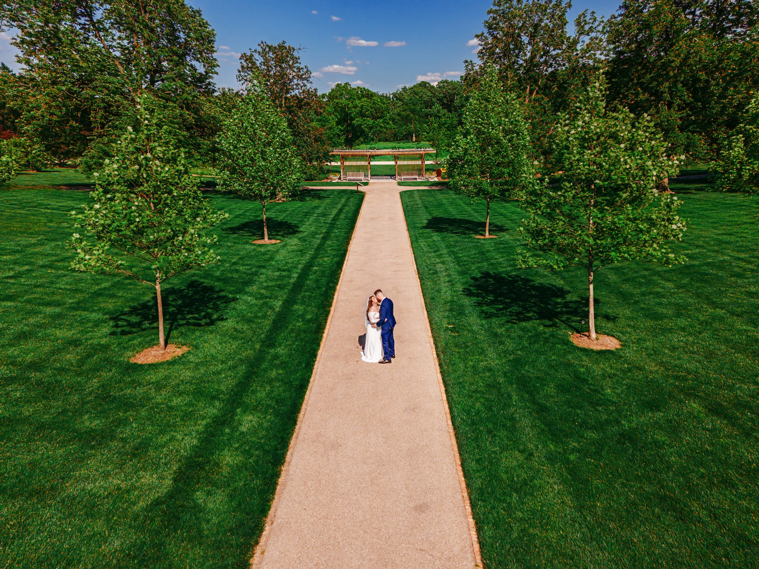 Aerial perspective destination wedding couple portrait in formal estate gardens