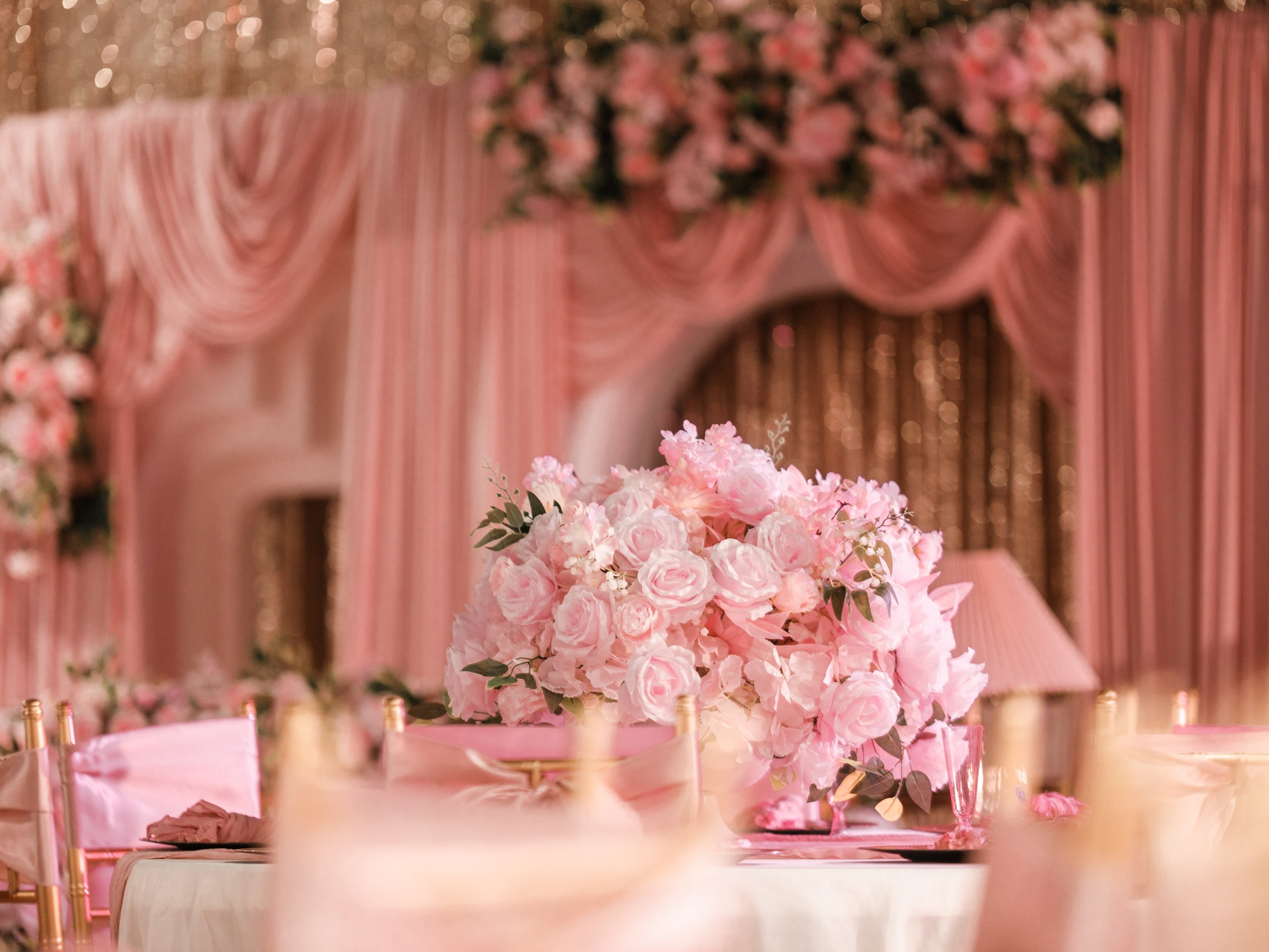 Blush pink rose floral centerpiece and draped backdrop at Star Events