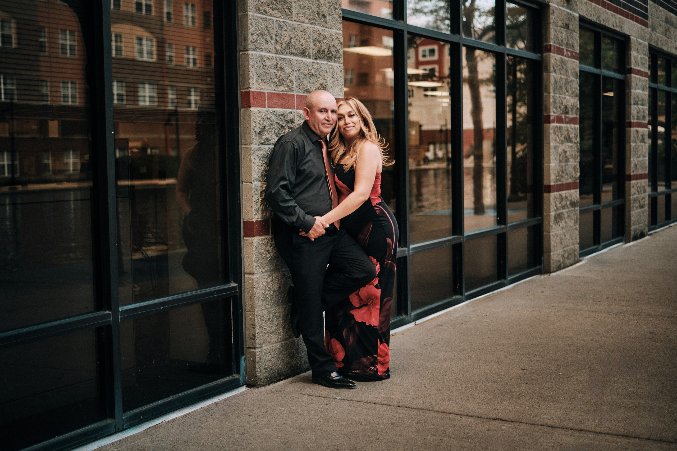 Modern couple engagement session outside urban building in Downtown Indianapolis