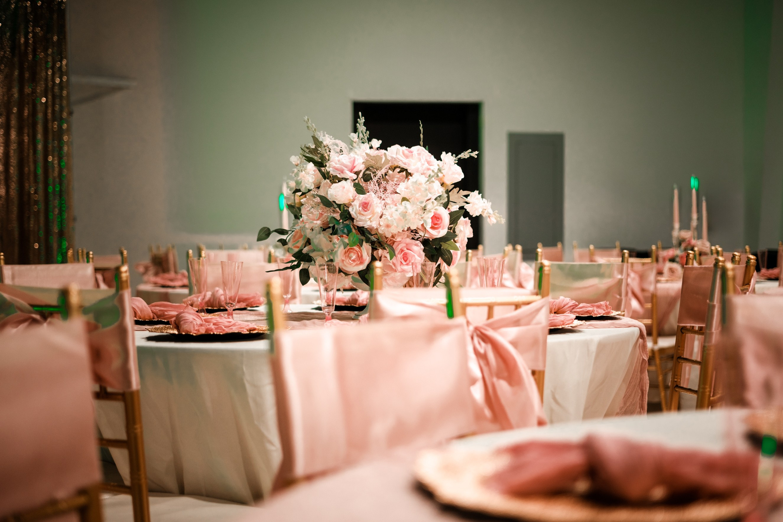 Elegant guest table setting with rose florals and warm ambient lighting