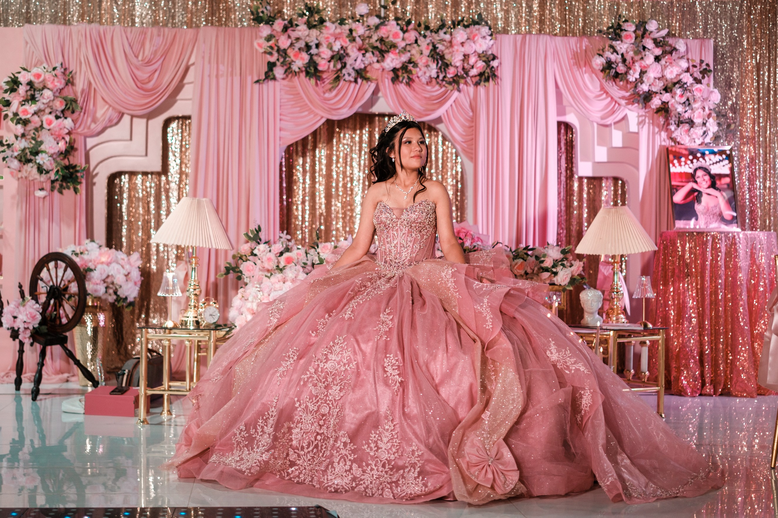 Custom event backdrop with blush pink draping, floral styling, and warm ambient lighting