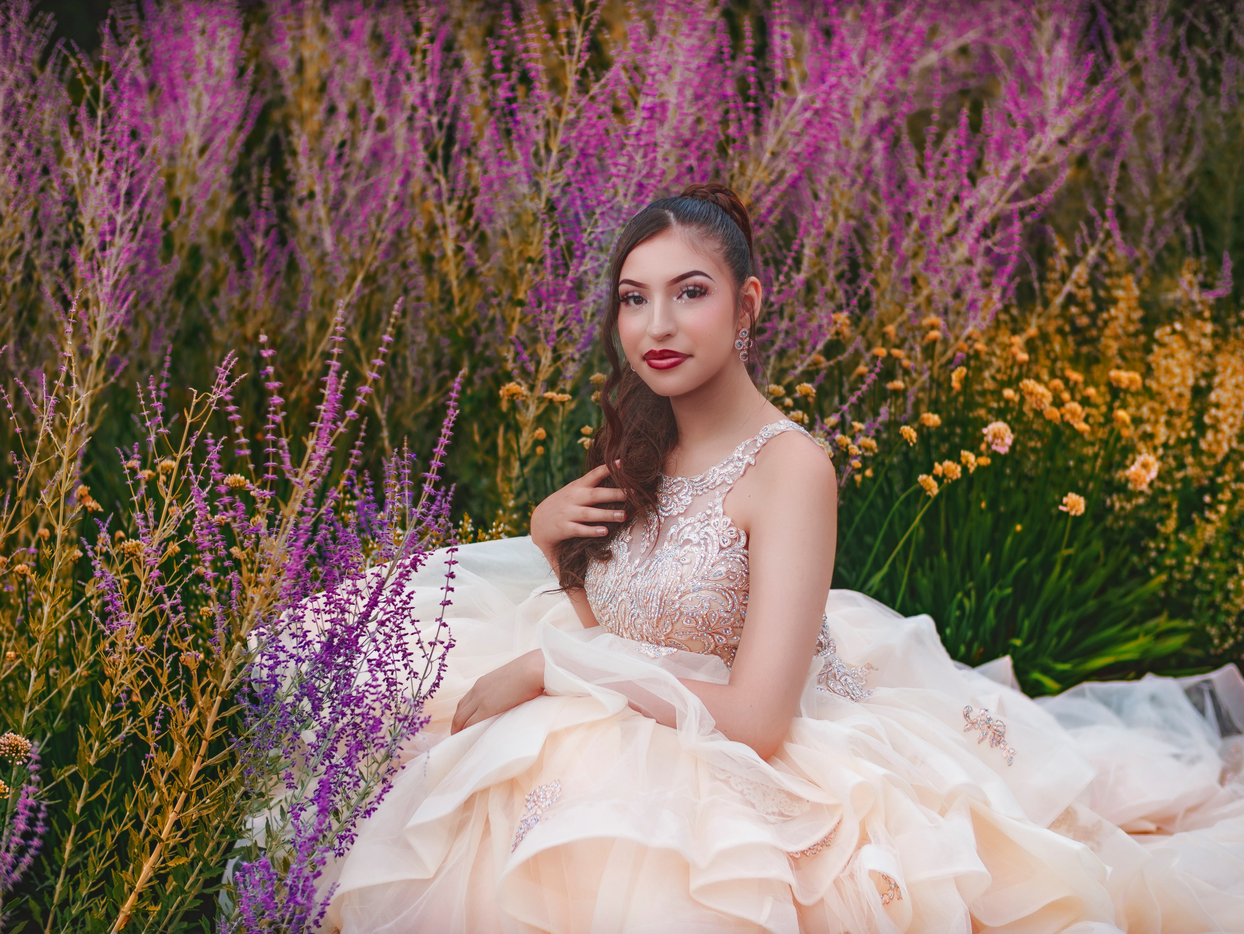 Dreamy fine art quinceañera photoshoot surrounded by flowers in Indianapolis park