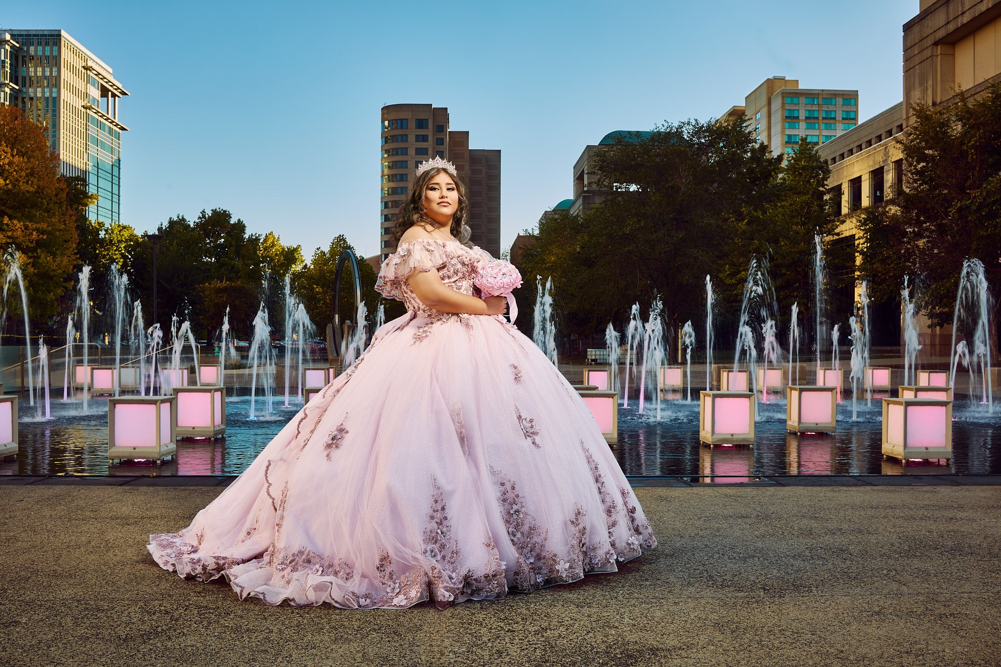 Fine art quinceañera portrait in pastel lilac dress at city plaza at dusk