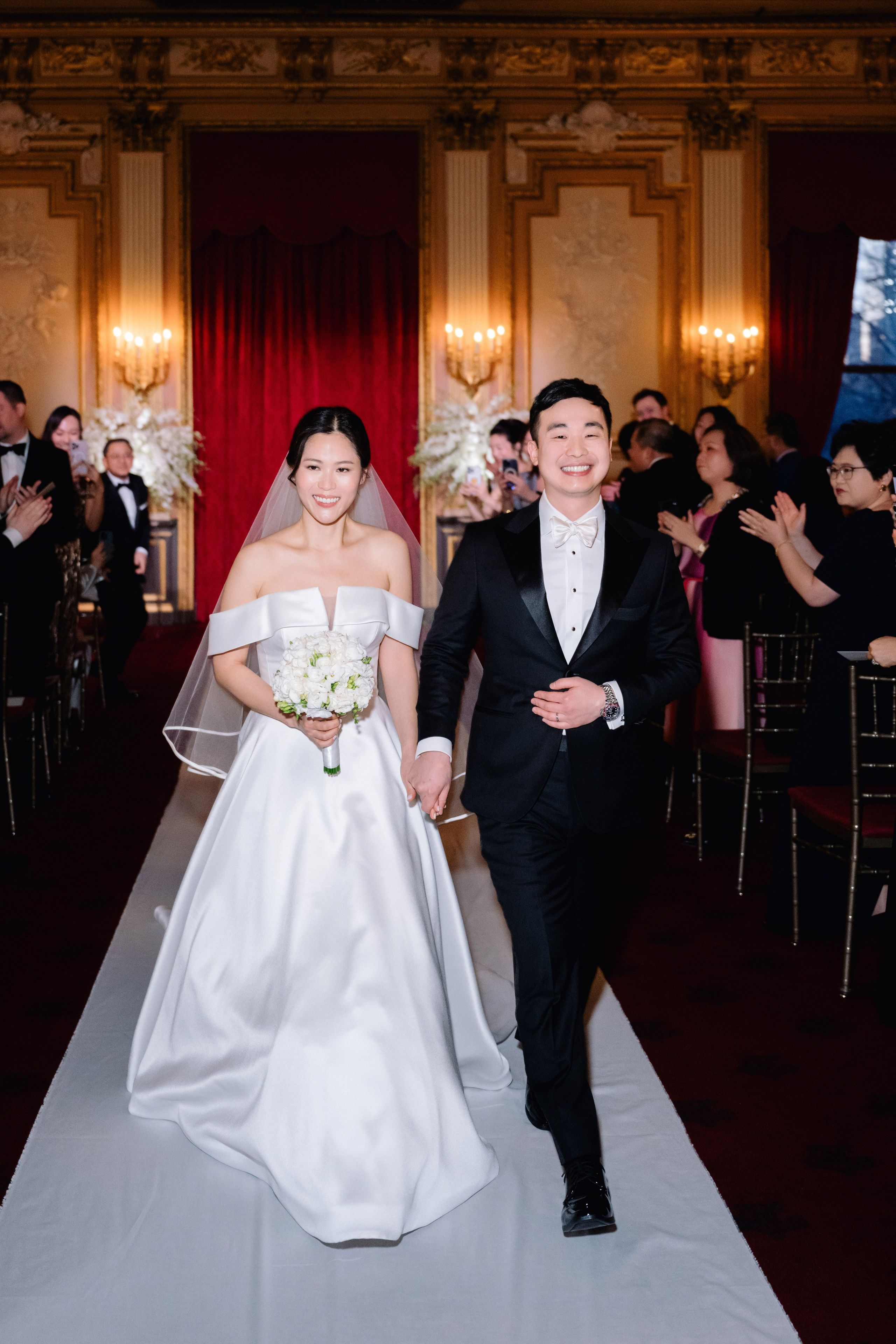 a bride and groom walking down the aisle