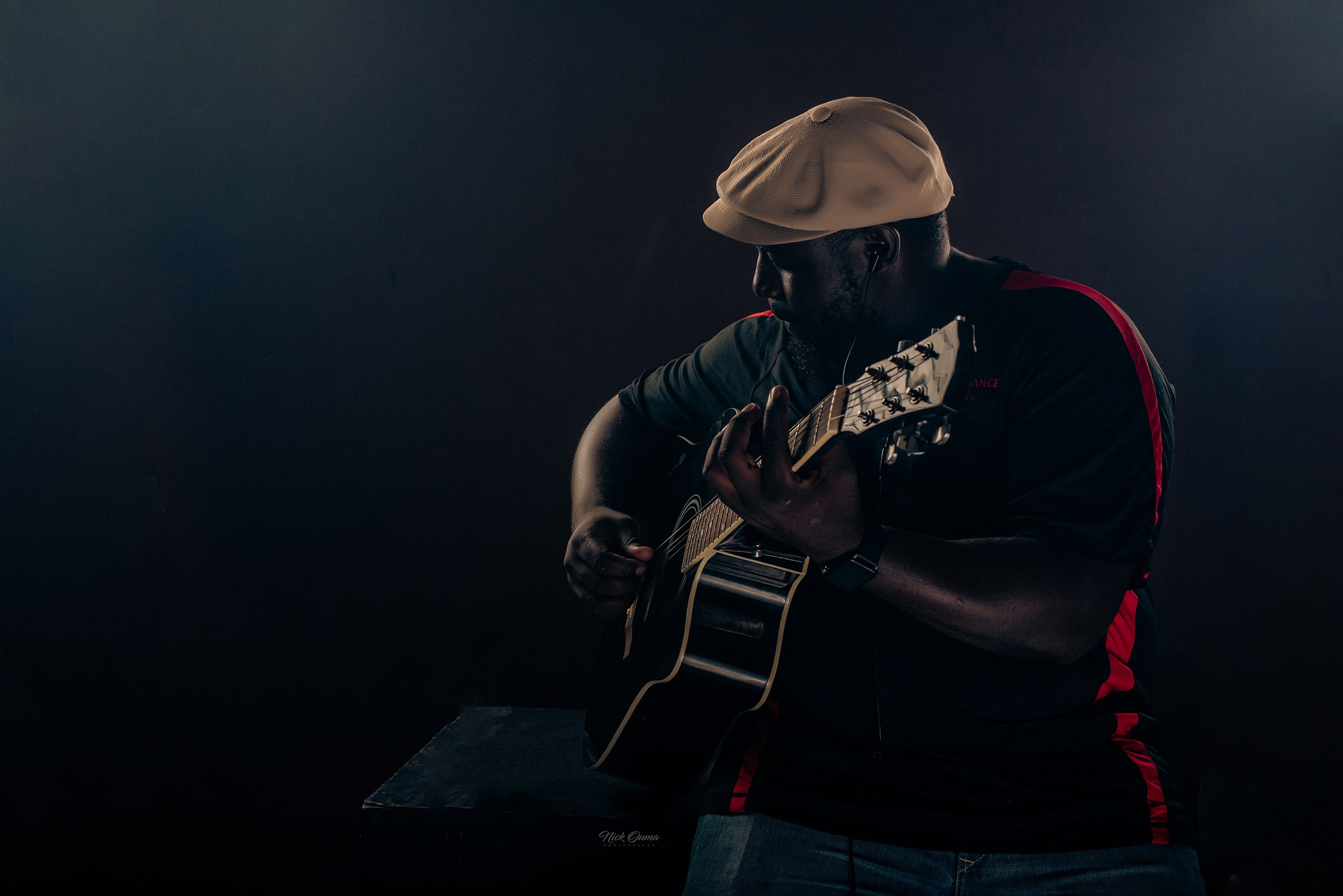 Dramatic studio portrait of a musician playing a guitar-fine art studio photography