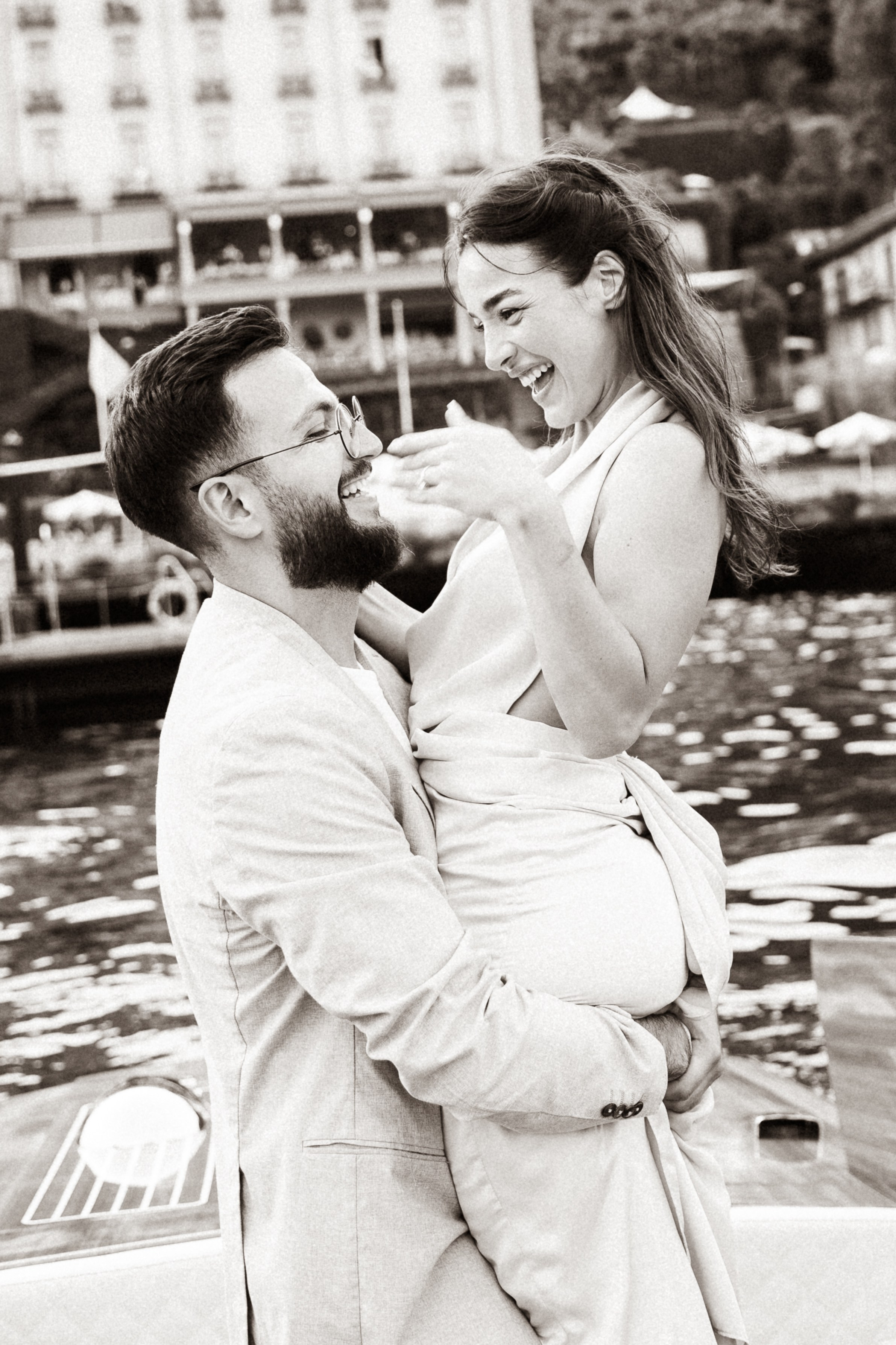 Couple sharing a romantic moment on a boat with views of Grand Hotel Tremezzo