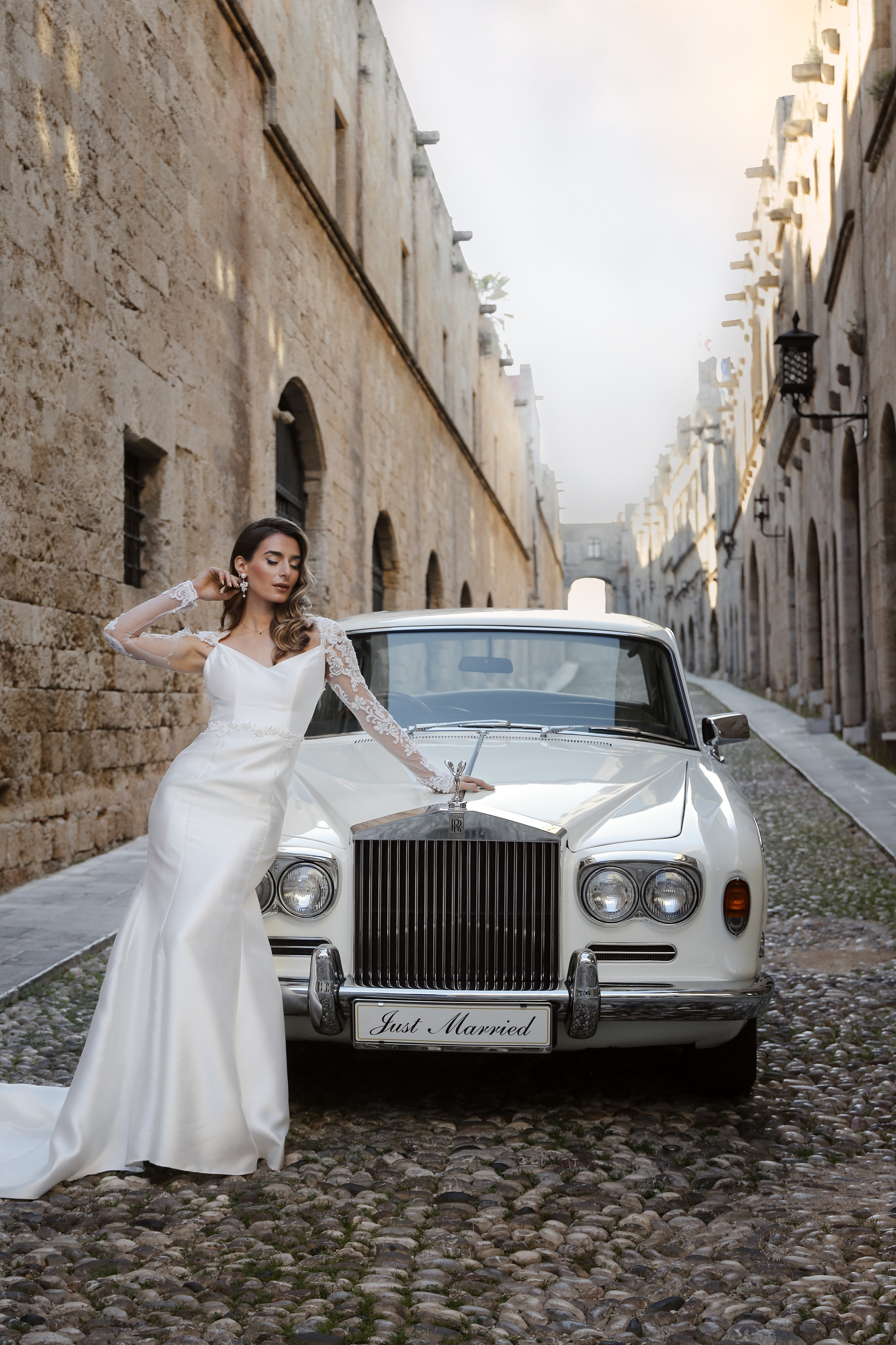 A bride next to Rolls Royce in old town of Rhodes island, Greece