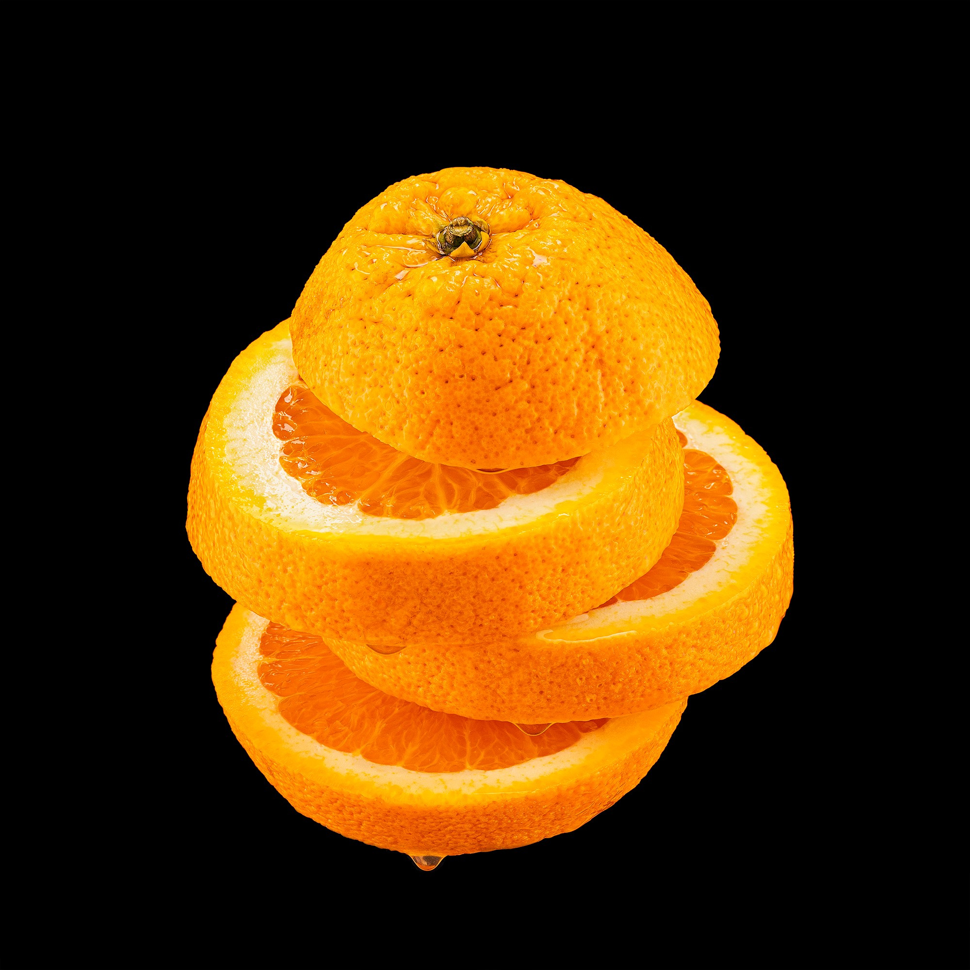 Photographer Roman Djuzev - Levitation of cut orange on a black background.